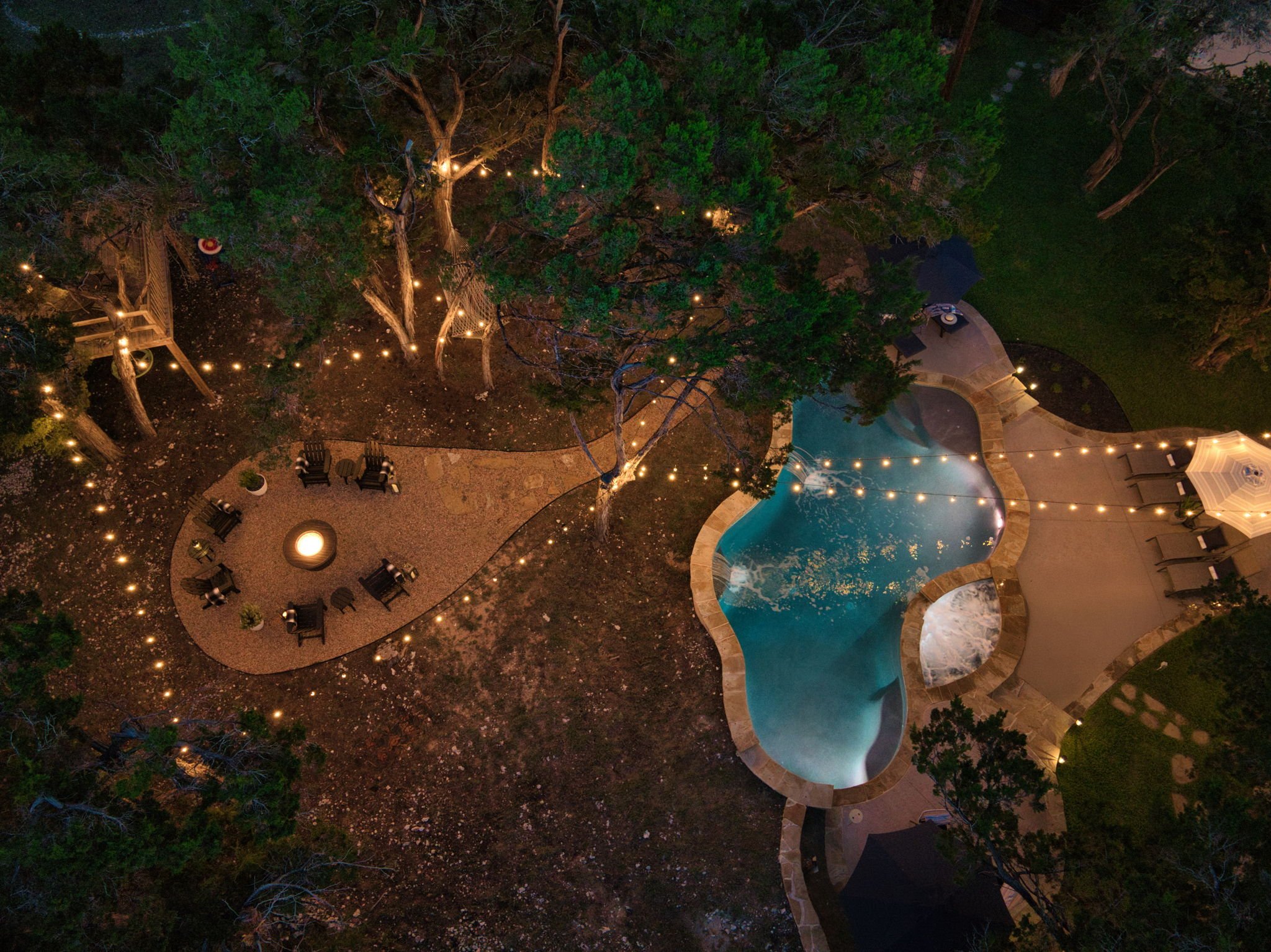 Refreshing Waterfall pool and Heated Spa with fire pit @Whitetail Cottage.