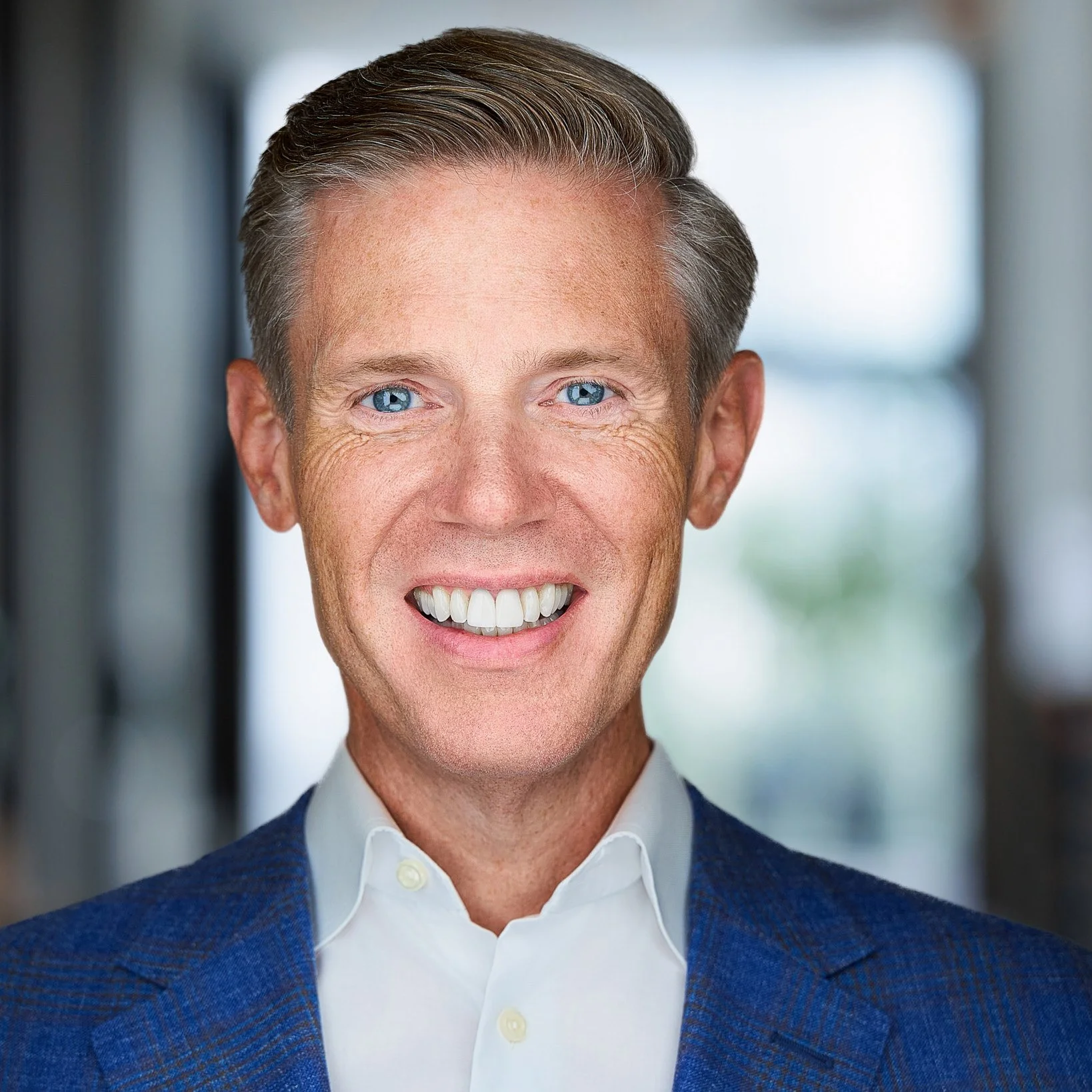 Dallas CEO headshot on office background. Jessica Mills Photography