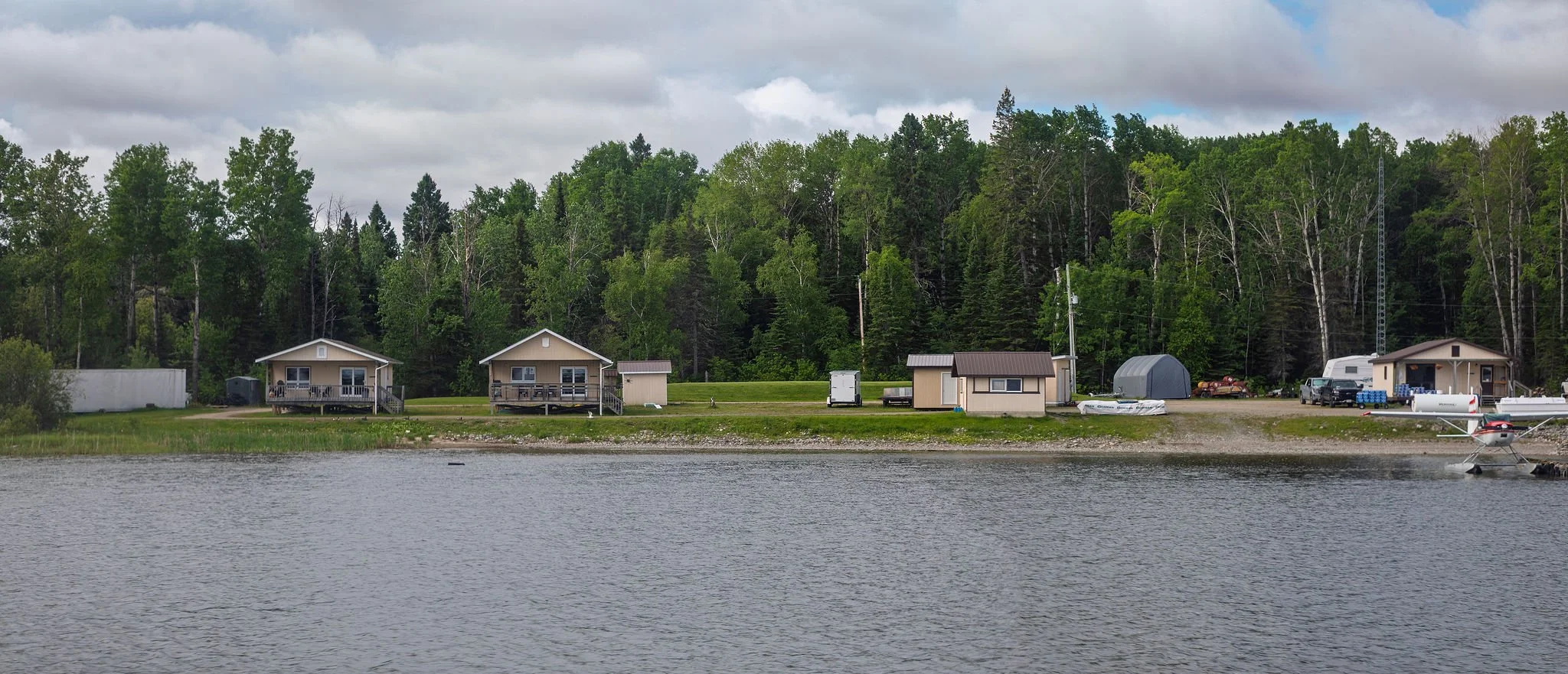 Cat Island Lodge's water base in Ear Falls, Ontario, Canada with 2 cabins, a dock, & vast trees & water