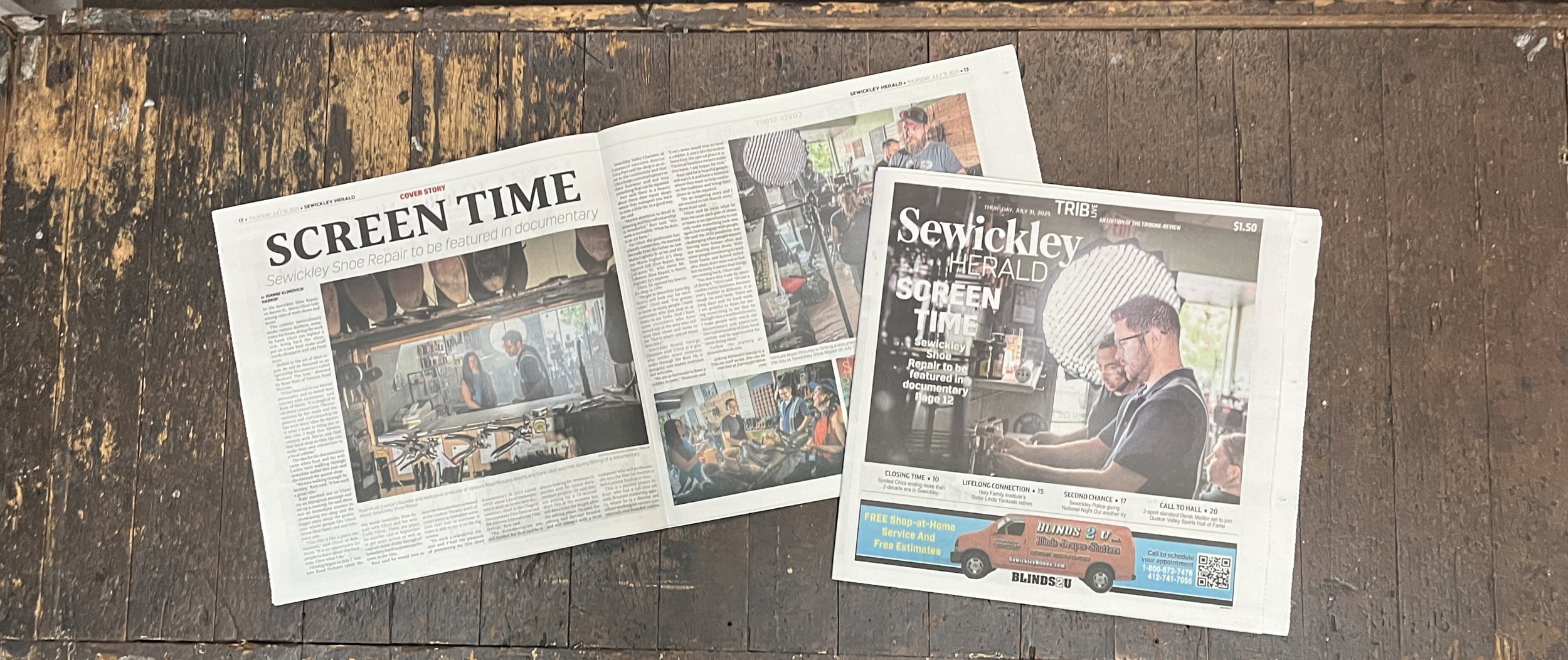 Two newspapers placed on a rustic wooden table. The left newspaper is titled 'SCREEN TIME' and features a story about Sewickley Shoe Repair with photos of inside the shop. The right newspaper is titled 'SEWICKLEY HERALD' with a headline 'SCREEN TIME' and photos of people in a shop, including a man and woman sitting at a table, and an advertisement at the bottom.