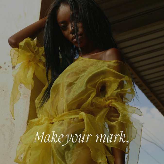 A woman wearing a yellow ruffled off-shoulder dress leaning against a wall outdoors with a partially cloudy sky in the background.