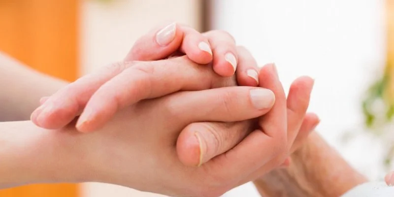 Holding someones hand to comfort them