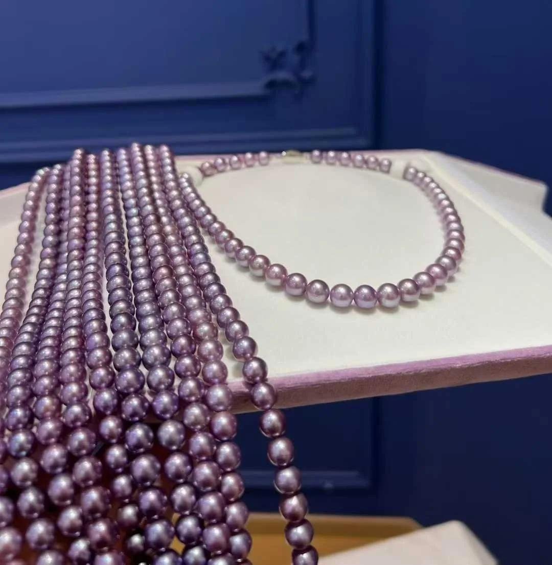 Hand-selected royal purple cultured freshwater pearl strands and necklace displaying deep violet metallic luster.