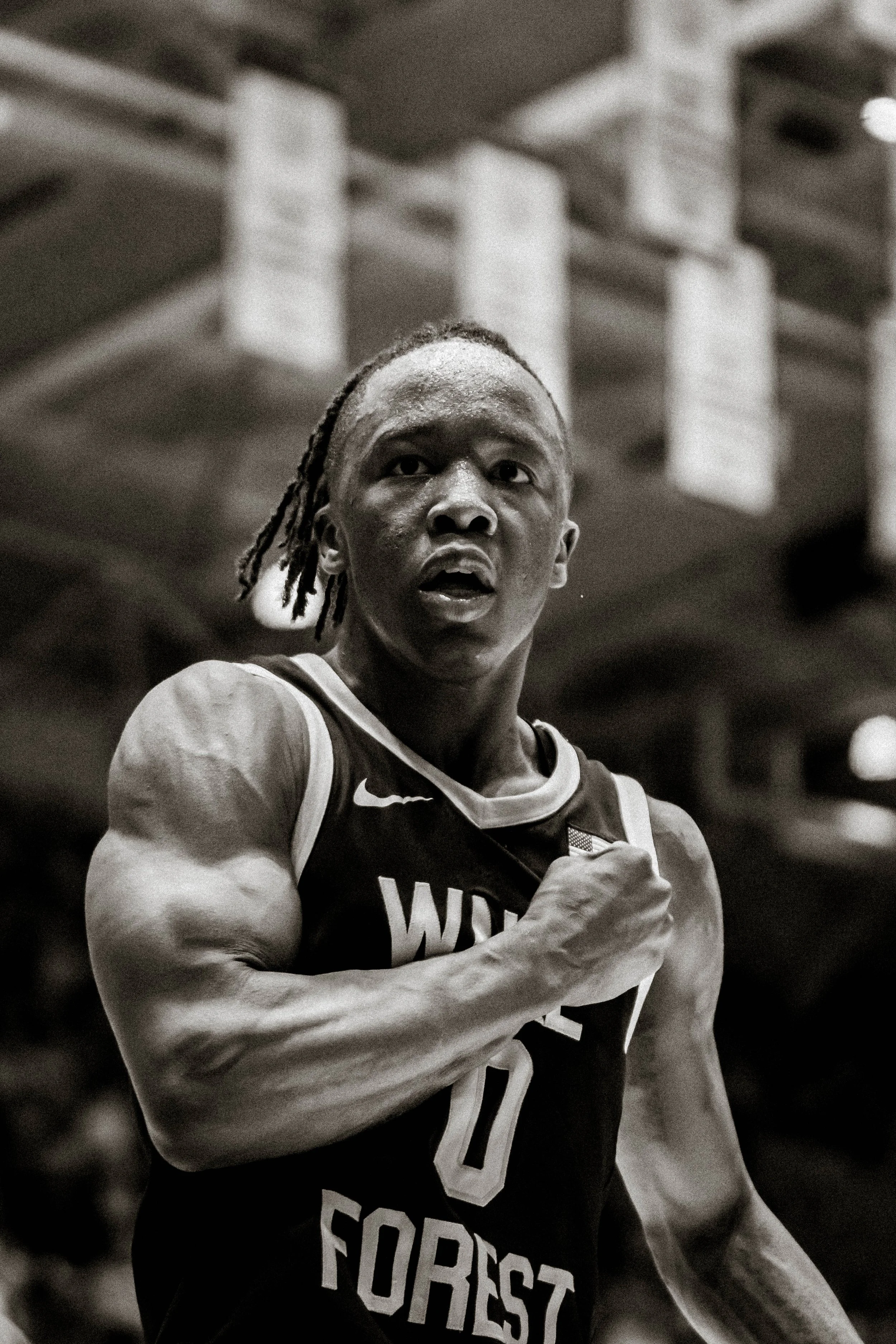 Black and white image of a basketball player wearing a "Wake Forest" jersey with number 0.