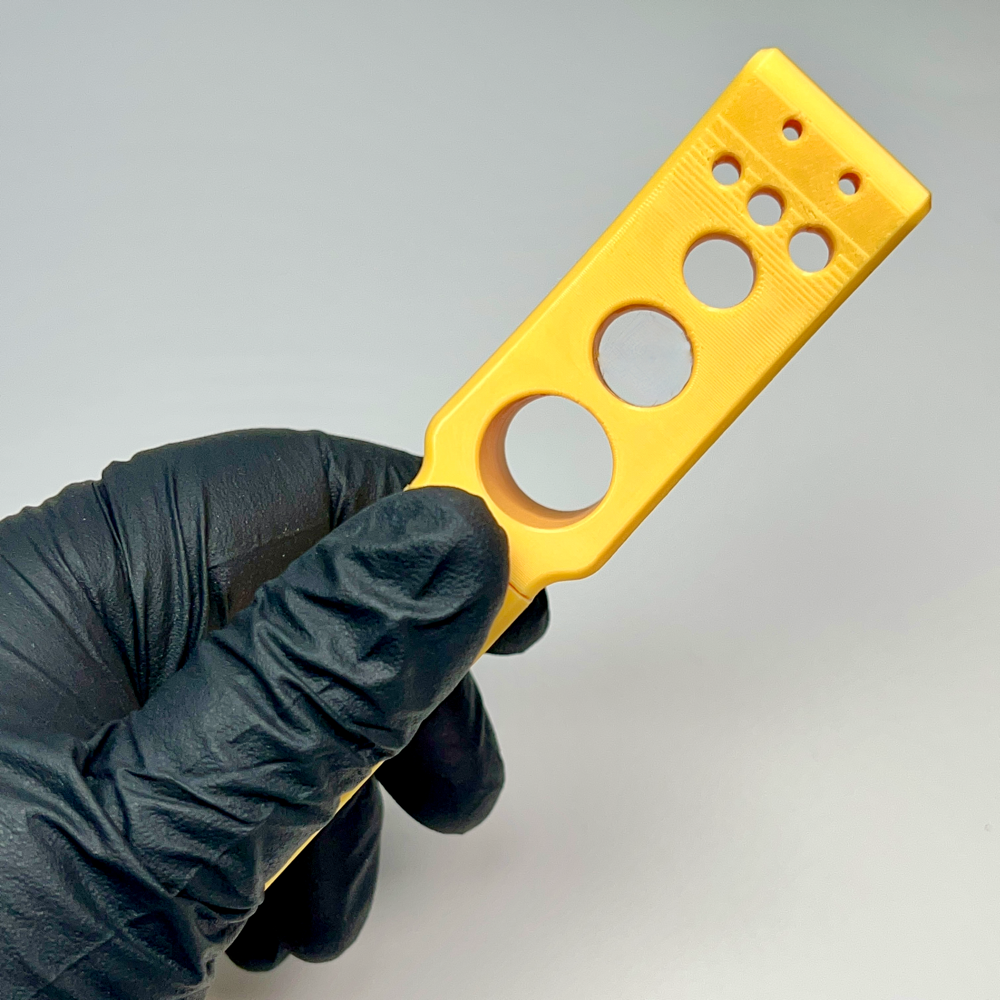 Herb stripper featuring the variety of hole sizes