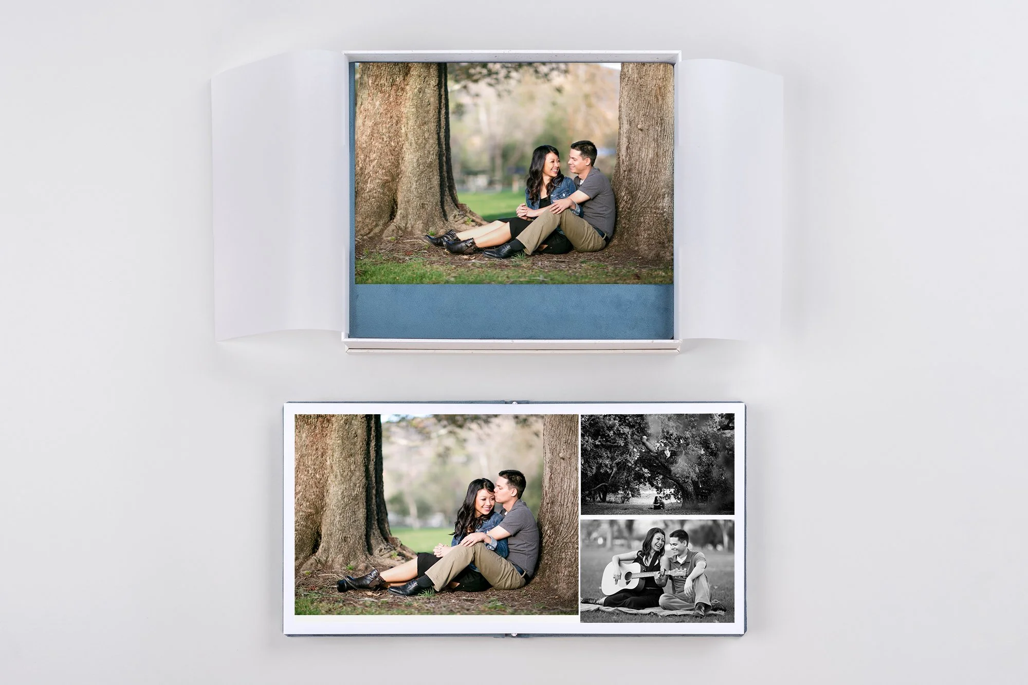 A couple holding hands and walking through a grassy field with mountains in the background, during a cloudy day.