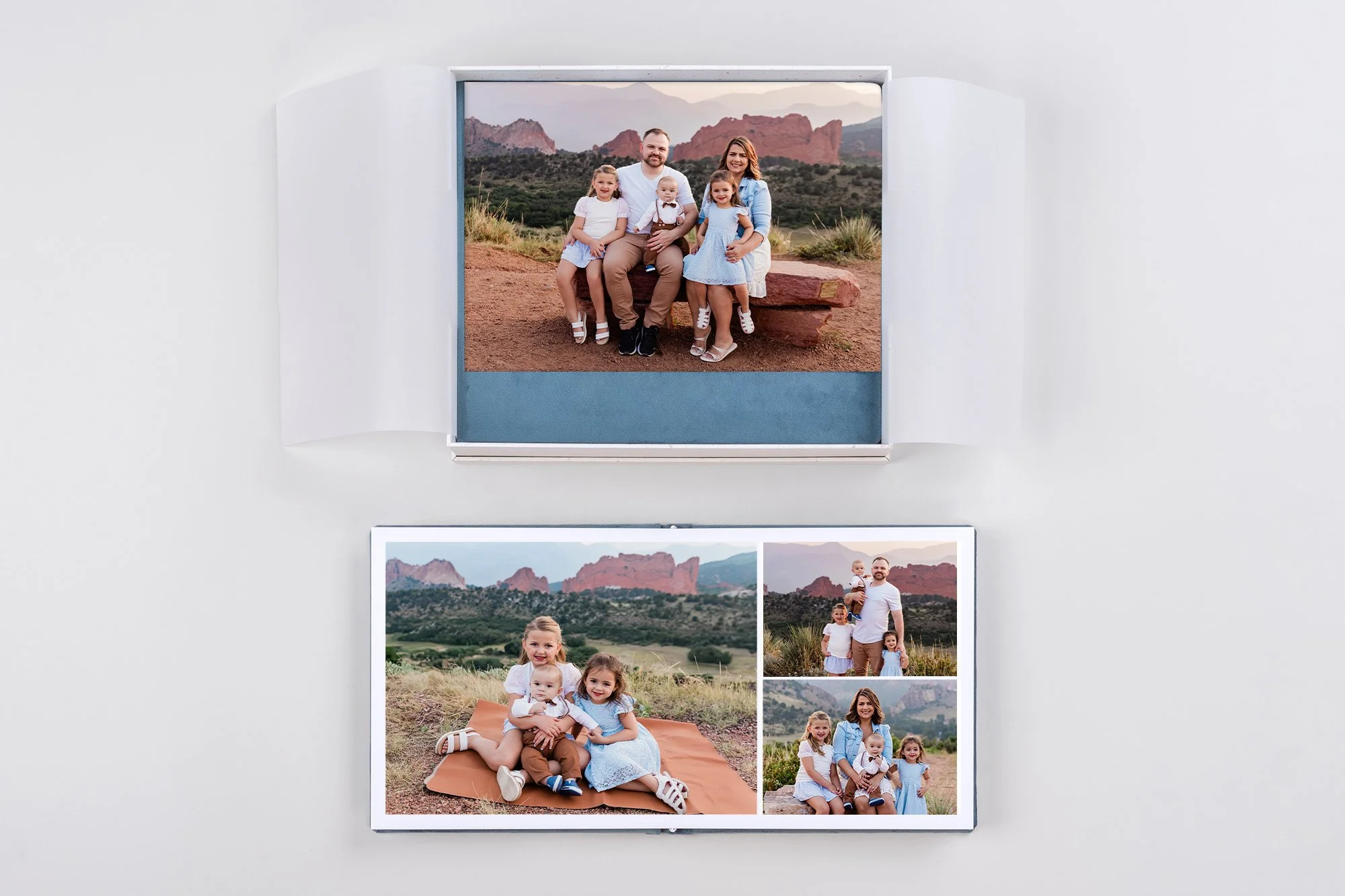 A couple holding hands and walking through a grassy field with mountains in the background, during a cloudy day.