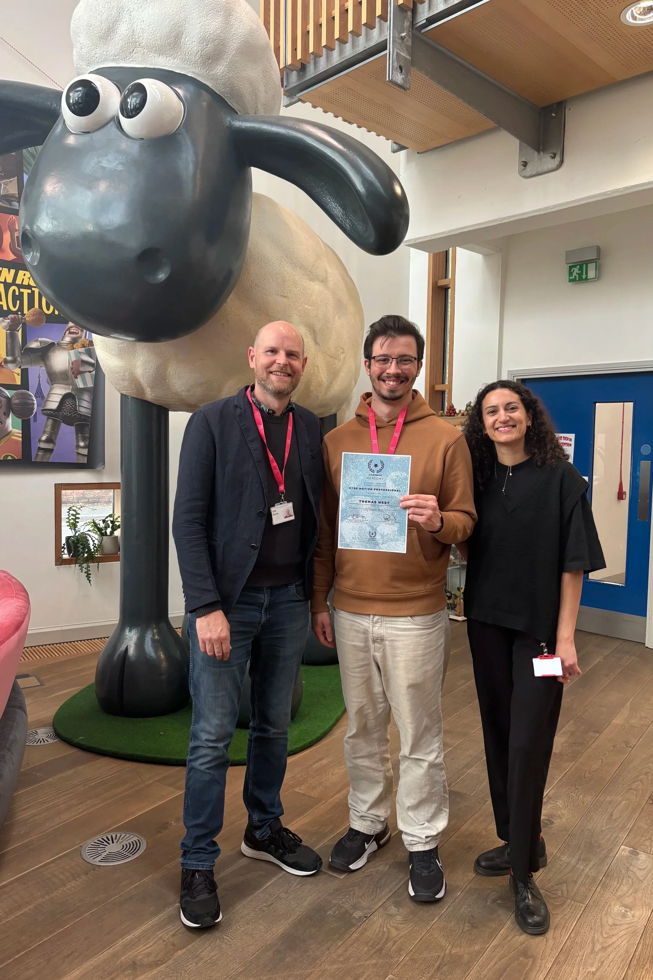 Thomas West, posing next to Will Becher and Amy Upchurch for Thomas's Graduation day from Aardman Academy's Professional Course.