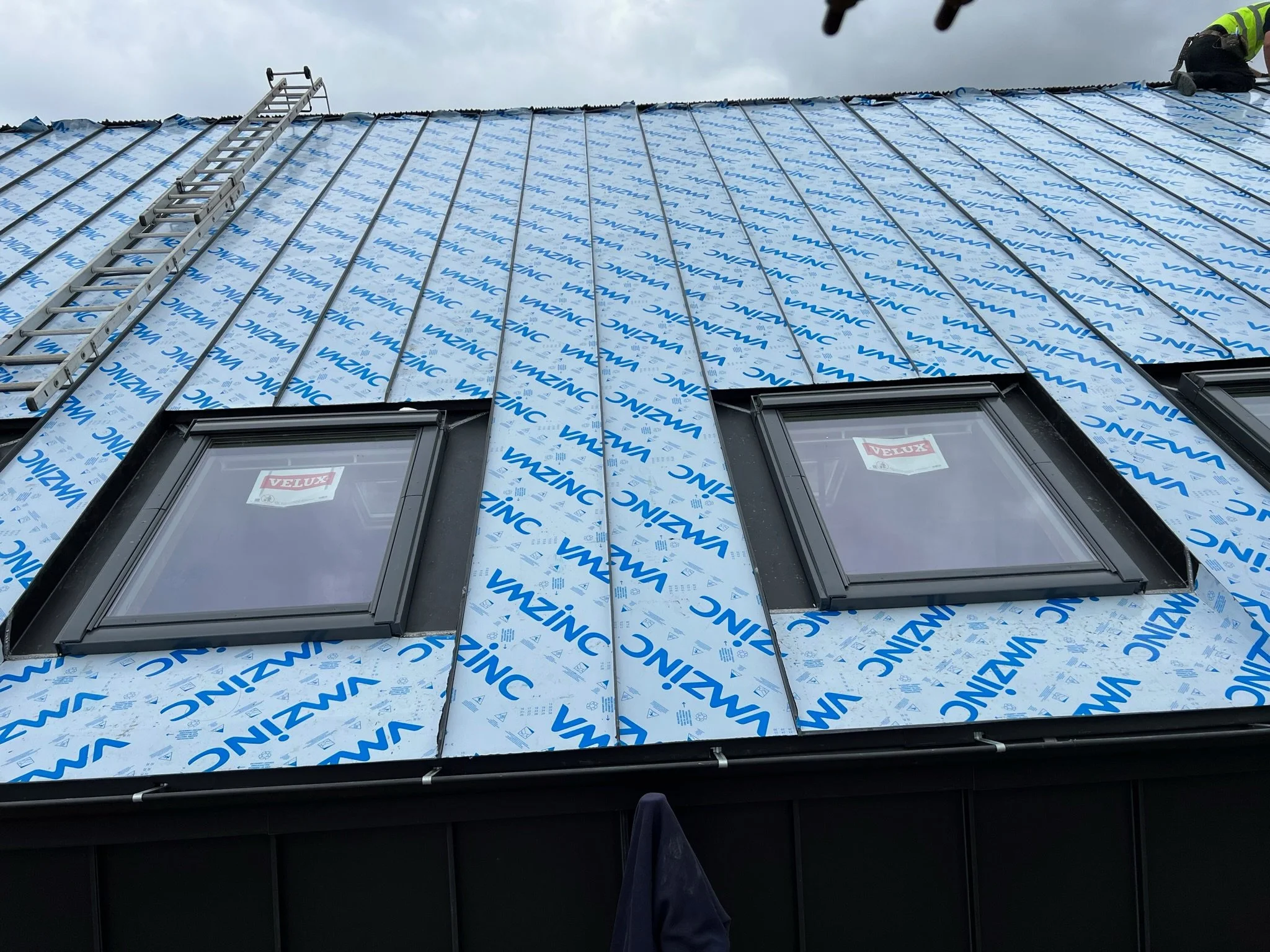 Roof with VMZINC covering, two Velux windows, and a ladder