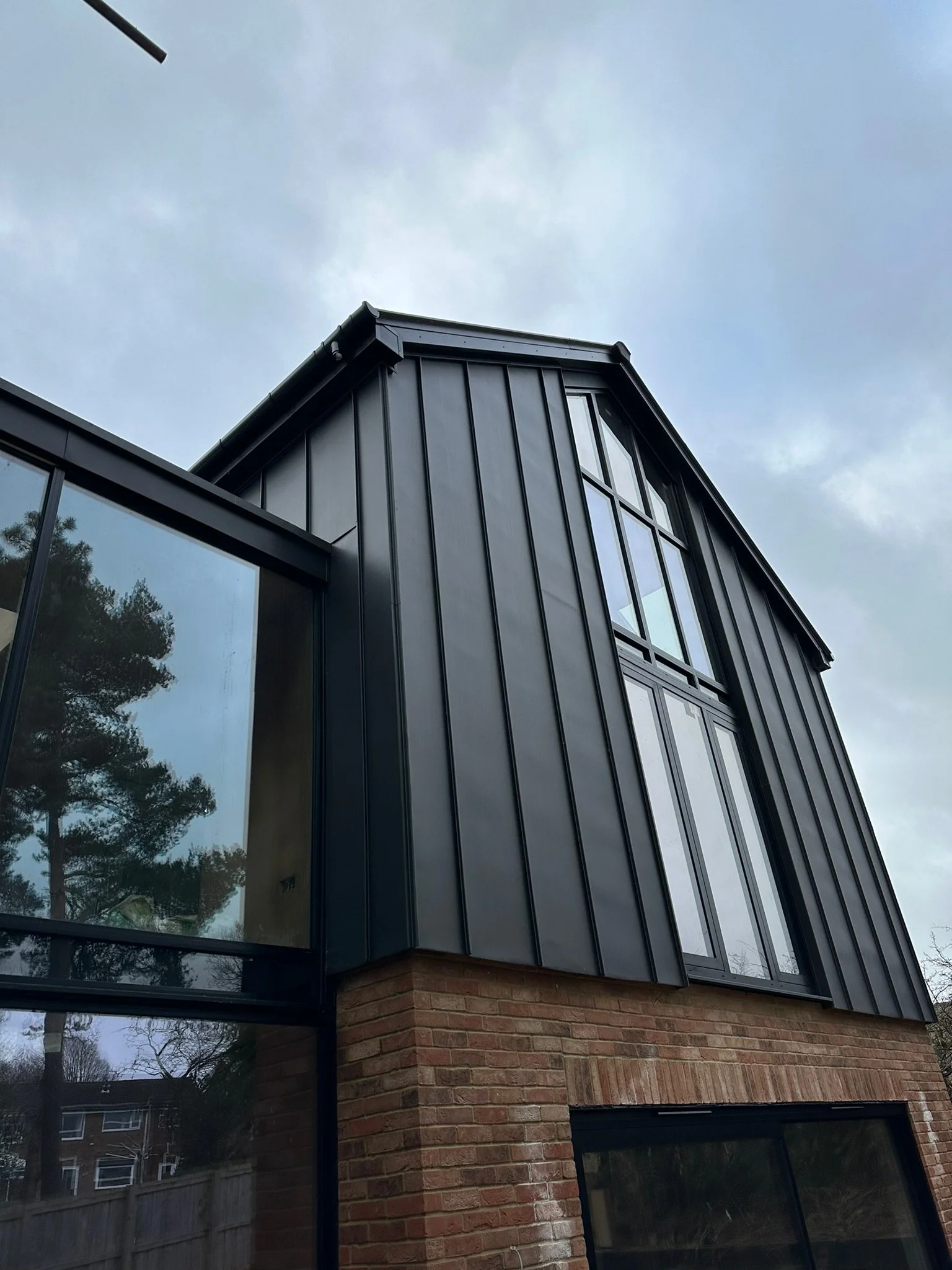 Modern building with black metal cladding and large windows