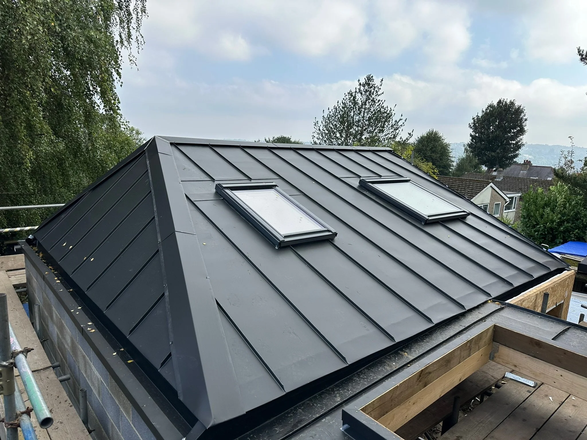 Metal roof with skylights in residential area