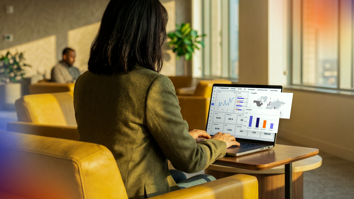 Professional analyzing marketing performance dashboards on a laptop, representing ongoing monitoring and optimization of automated digital marketing campaigns.