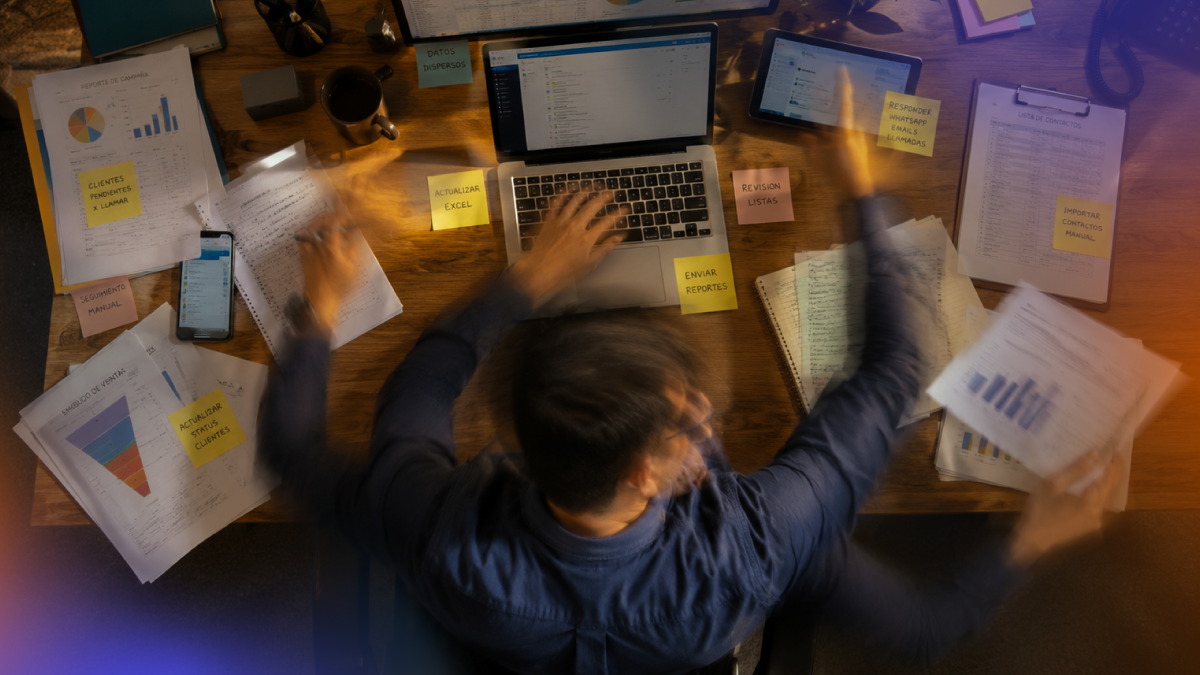 Person overwhelmed by repetitive administrative work, spreadsheets and manual follow-ups, representing inefficient sales processes that could be automated through a CRM platform.