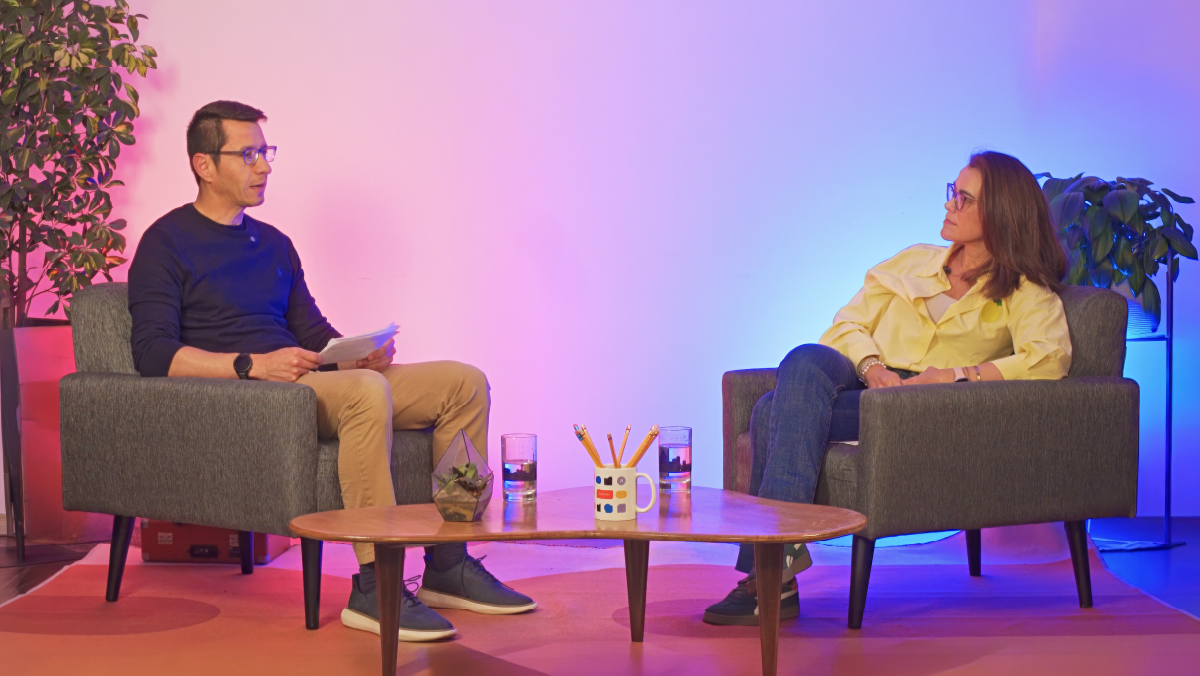 Two executives having a conversation in a podcast studio setting, representing an executive discussion on marketing-driven innovation and business transformation on The Dot Podcast.