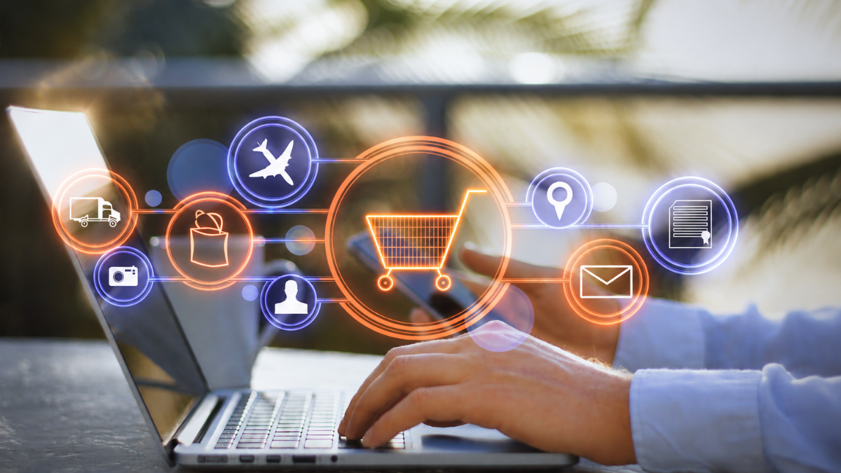 Person shopping online using a laptop and smartphone, with digital icons representing payments, shipping, customer accounts, communication, and order management, illustrating an integrated e-commerce ecosystem.