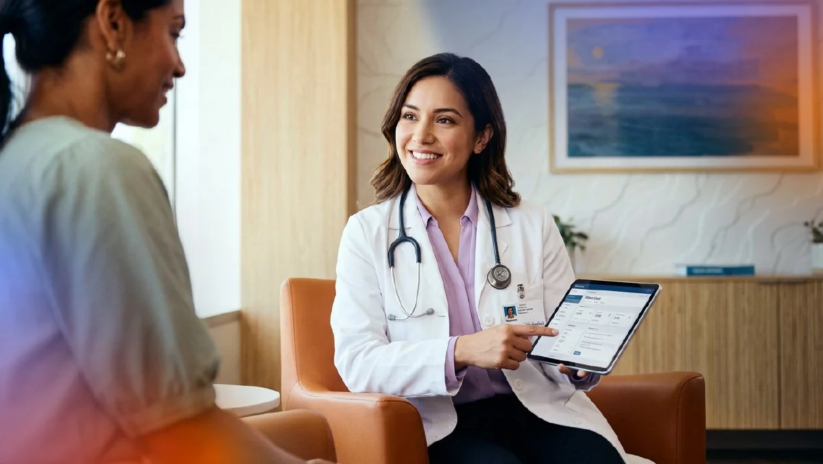 Healthcare professional showing digital information on a tablet while speaking with a patient, representing connected and personalized healthcare experiences.