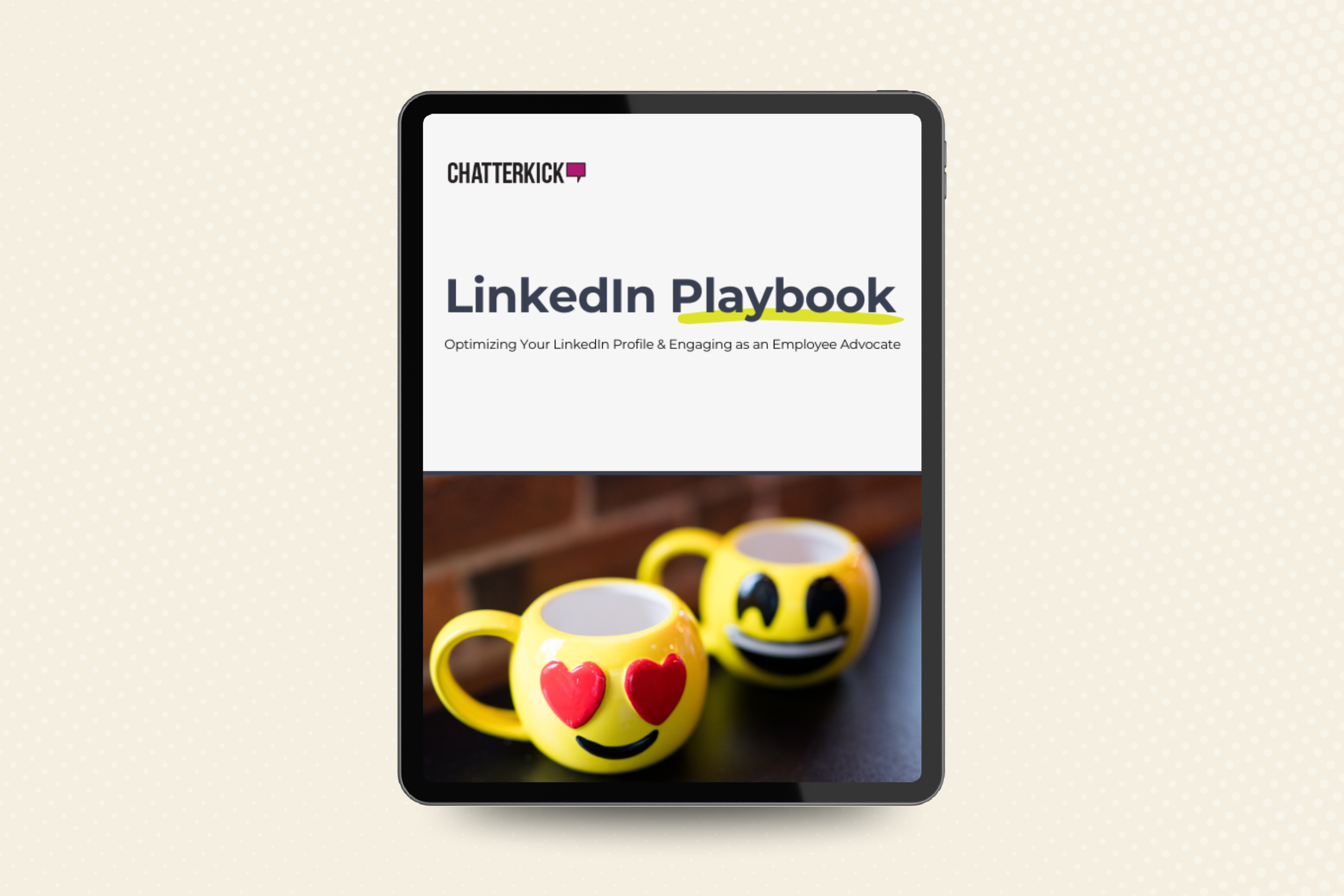 A tablet displaying a cover page titled 'LinkedIn Playbook' with a subtitle 'Optimizing Your LinkedIn Profile & Engaging as an Employee Advocate.' Below the title are two yellow coffee mugs with smiley face emojis, one with heart eyes and the other with a wide smile, sitting on a dark surface against a brick wall background.