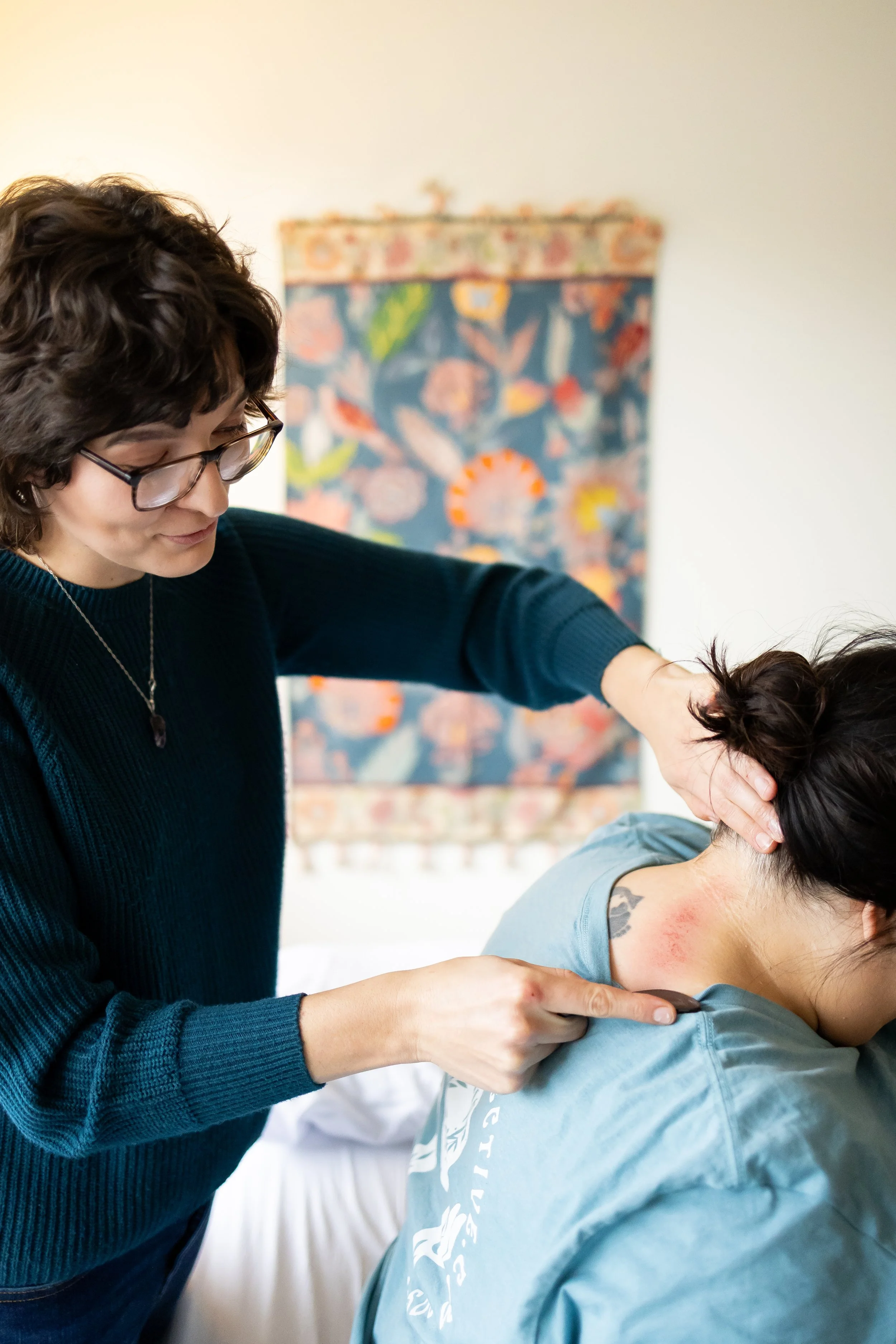 Gua Sha bodywork technique used by Dr. Bobi Farrow to relieve tension and support circulation — Lincoln, Nebraska office.