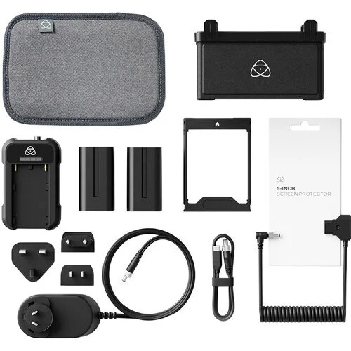A collection of camera accessories including a gray carrying case, a black battery box, two camera batteries, a lens filter, a screen protector, a power adapter, a USB cable, a coiled cable, and various mounting adapters and filters.