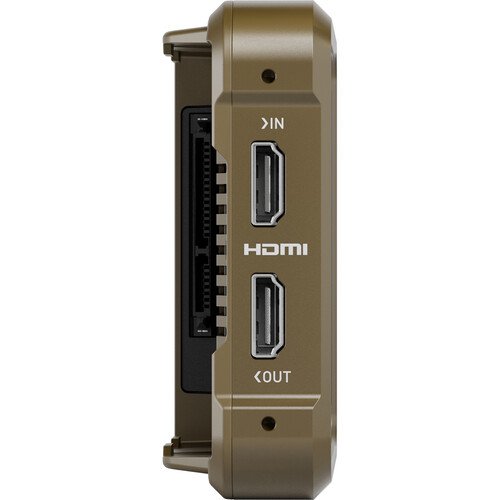Close-up of a device with HDMI ports labeled 'IN' and 'OUT' on a beige and black panel.