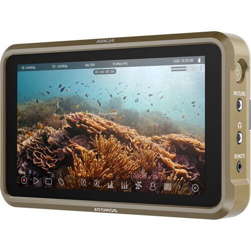 A portable monitor displaying a vibrant underwater scene with coral reefs and fish.