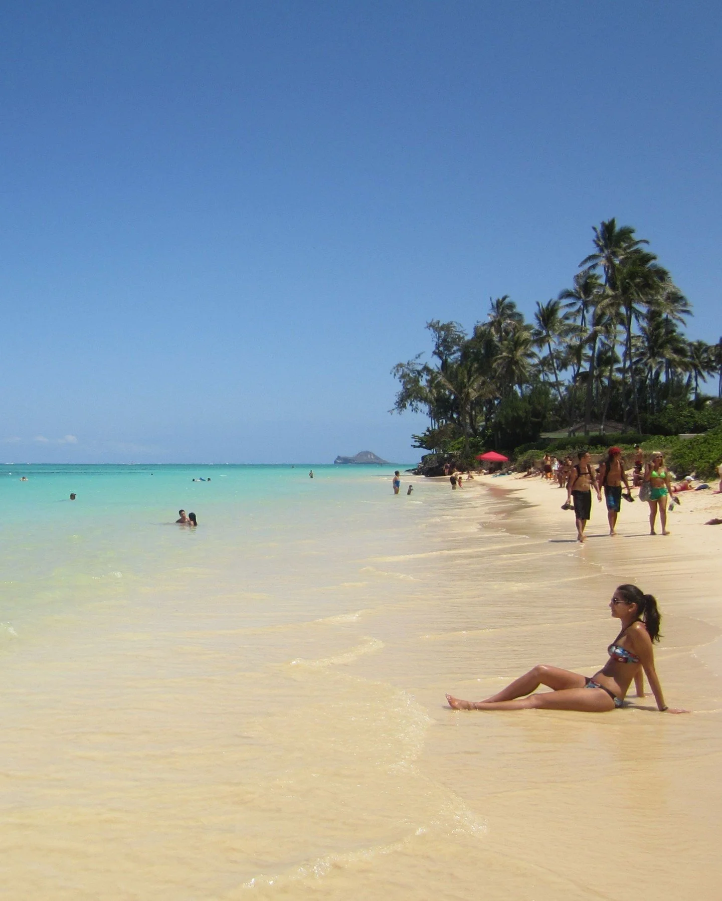 Located in Kailua on Oʻahu's windward coast, Lanikai Beach is famous for its soft white sand and crystal-clear turquoise water. 

The beach is known for its calm conditions, making it a favorite spot for swimming, kayaking, and paddleboarding. Offsho
