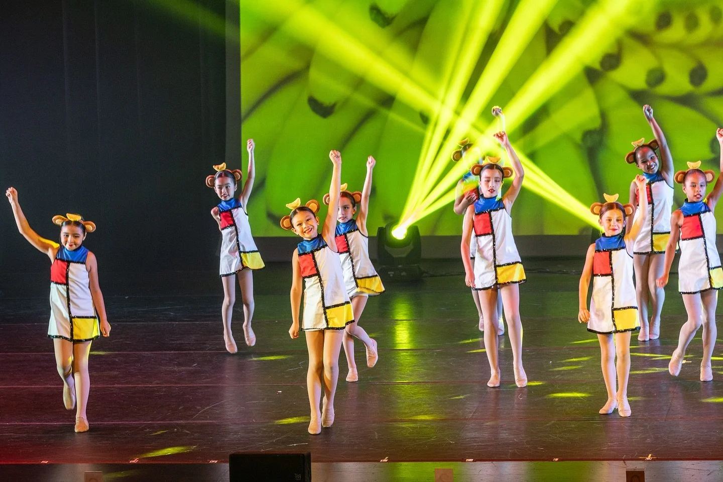 Young girls dancing on lit-up stage