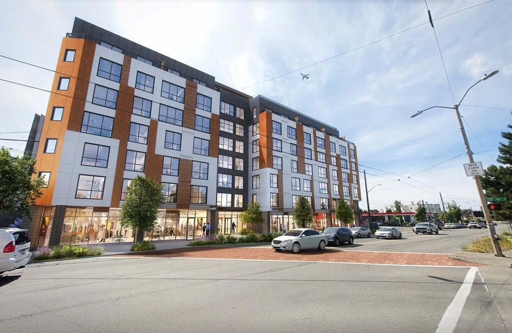 Modern multi-story apartment building with retail spaces on the ground floor