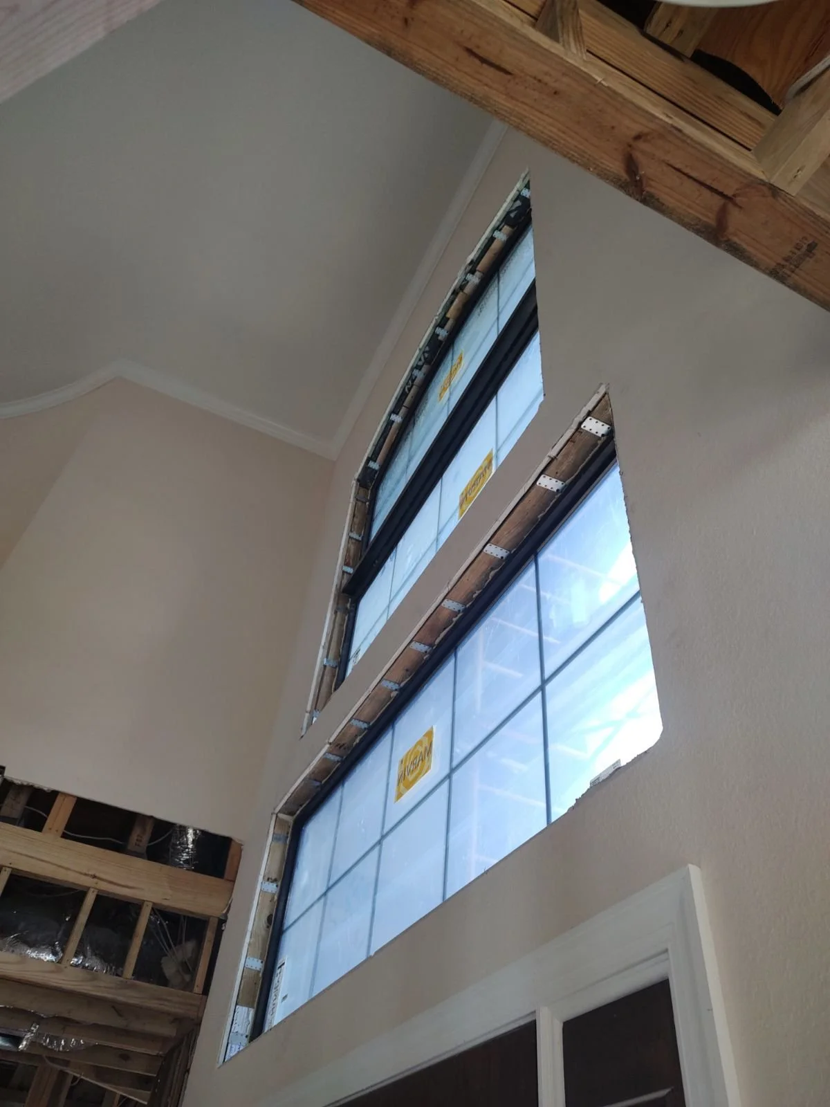 Grand foyer window above door. Impact window replacement