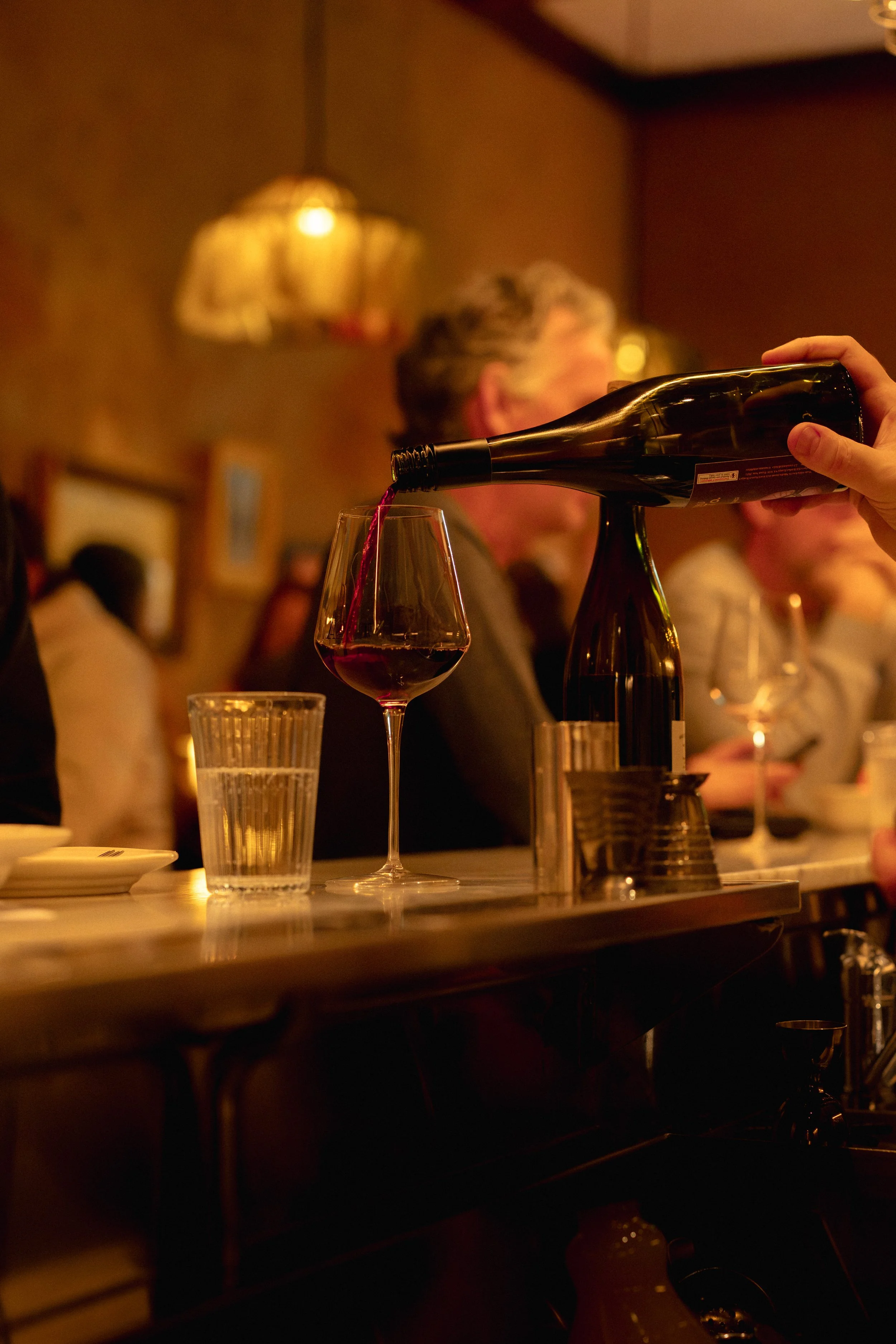 Wine being poured at Vineria Luisa, for the Wednesday Vino Club
