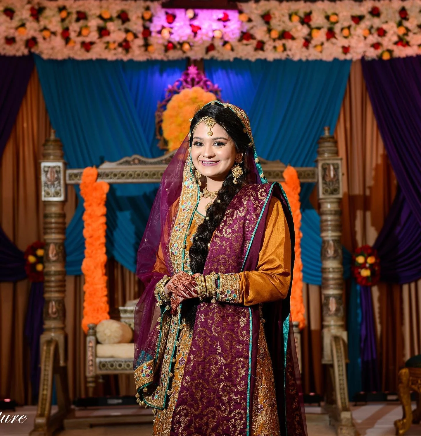 S O H A 
&bull;
Soha wanted a bronze neutral eye with a bolder purple lip to match her dupatta! We went for a glory, dewy, &amp; natural base for her Mehendi. For the hair, we did a long traditional braid and added flower pins. 
&bull;
#wedding #wedd