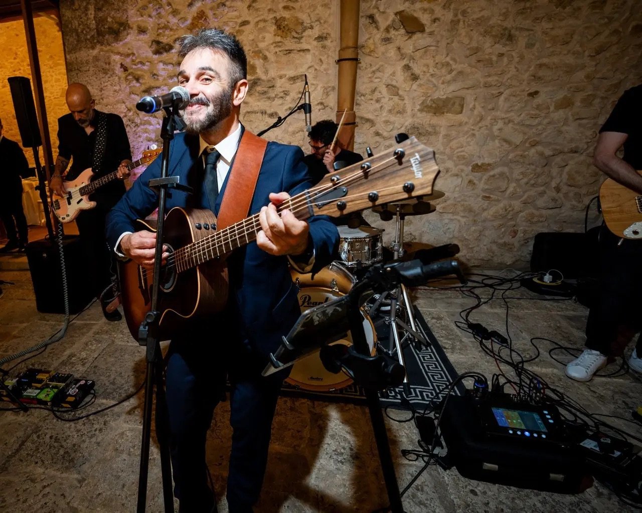 Lead singer of Riccardo's live wedding band performing at an Italian wedding reception.