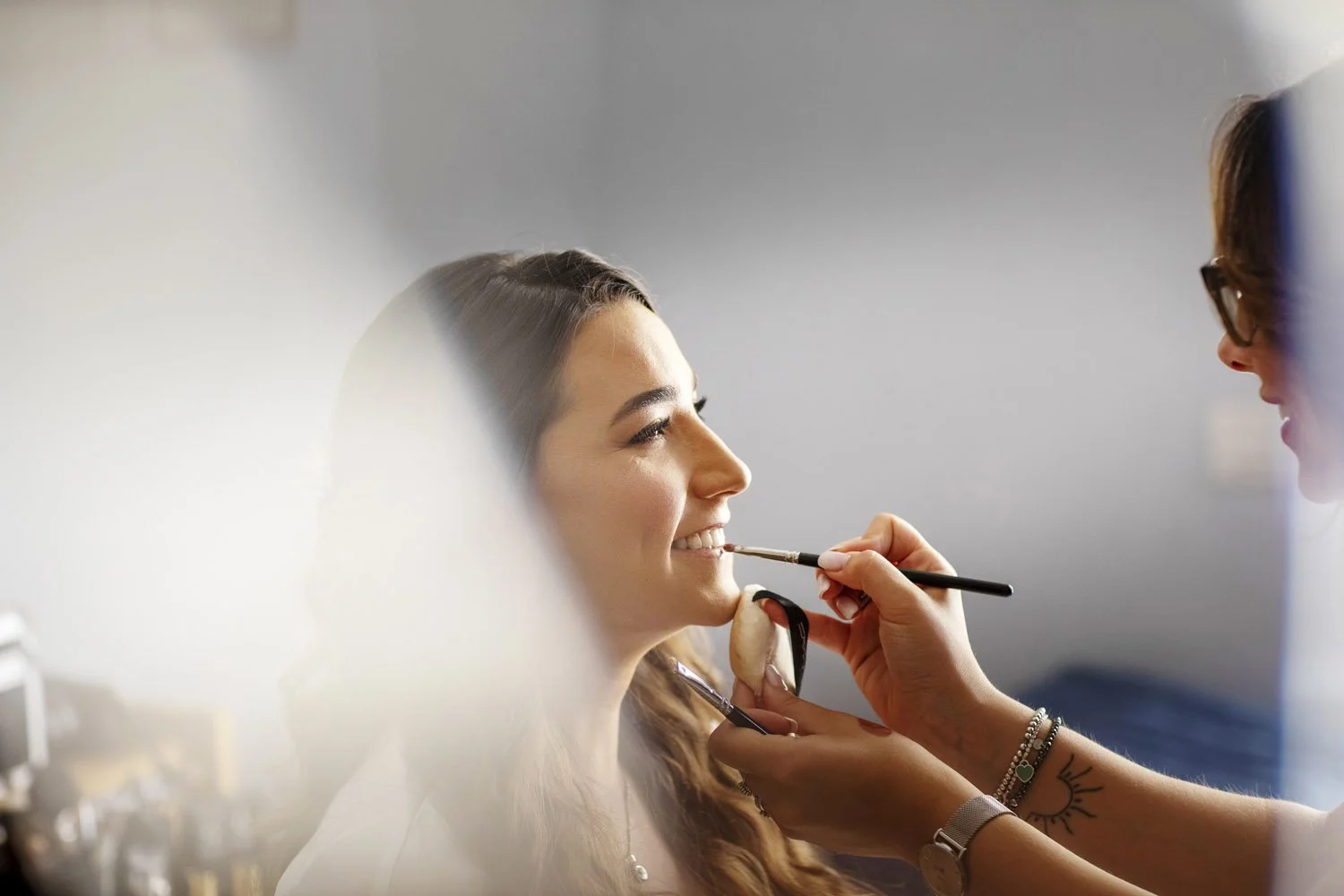 Professional bridal makeup artist Sonia Cuddemi creating a soft and radiant wedding makeup look