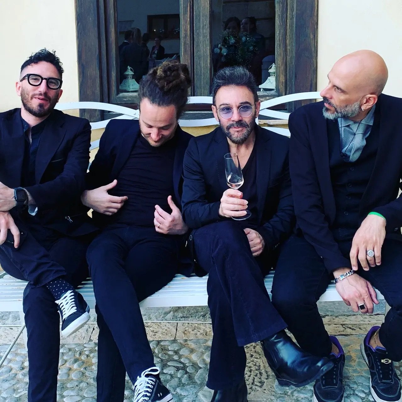 Members of Riccardo's live wedding band relaxing between performances at an Italian wedding venue.