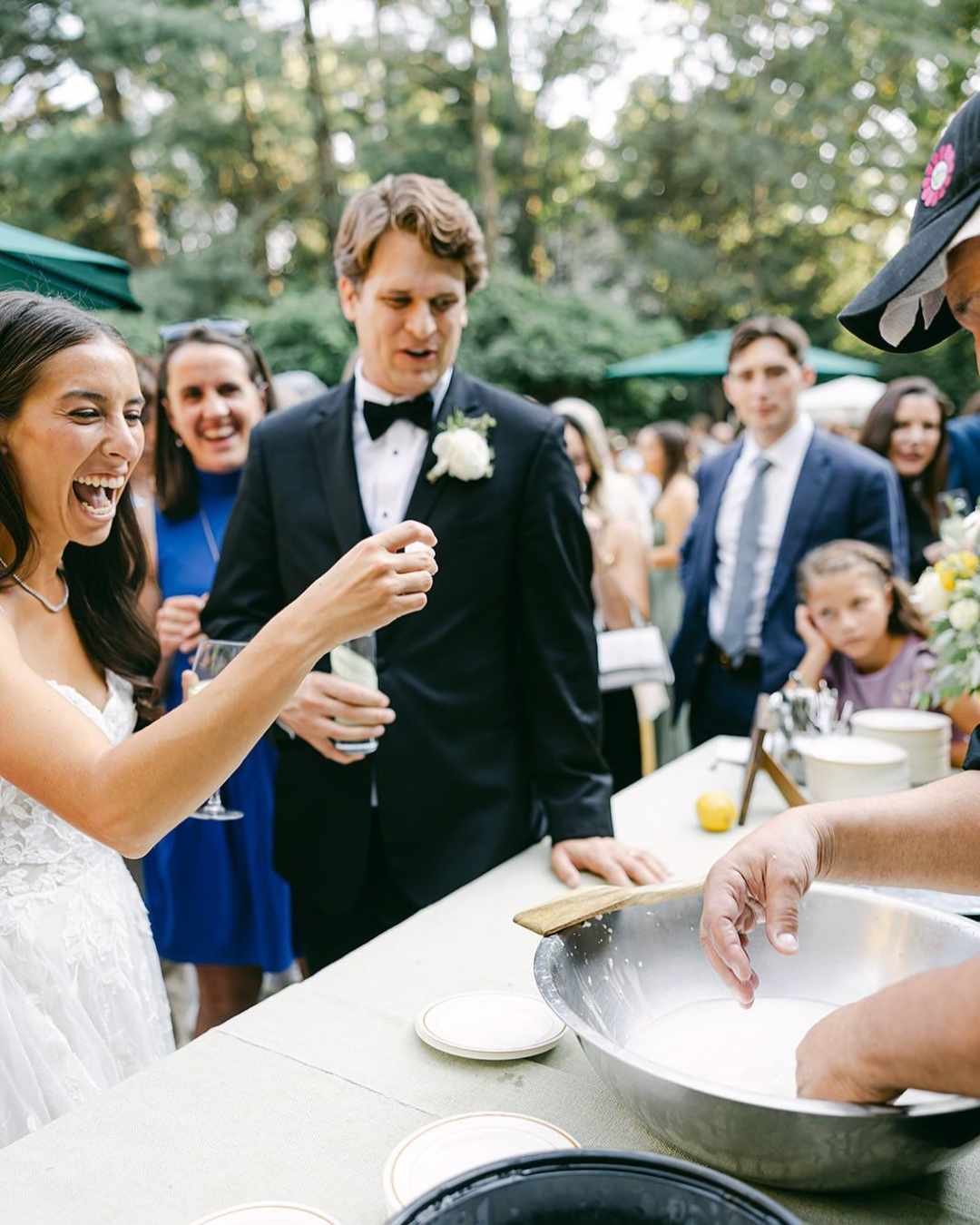 Live mozzarella-making station during Italian wedding aperitivo, with guests enjoying interactive food experiences.