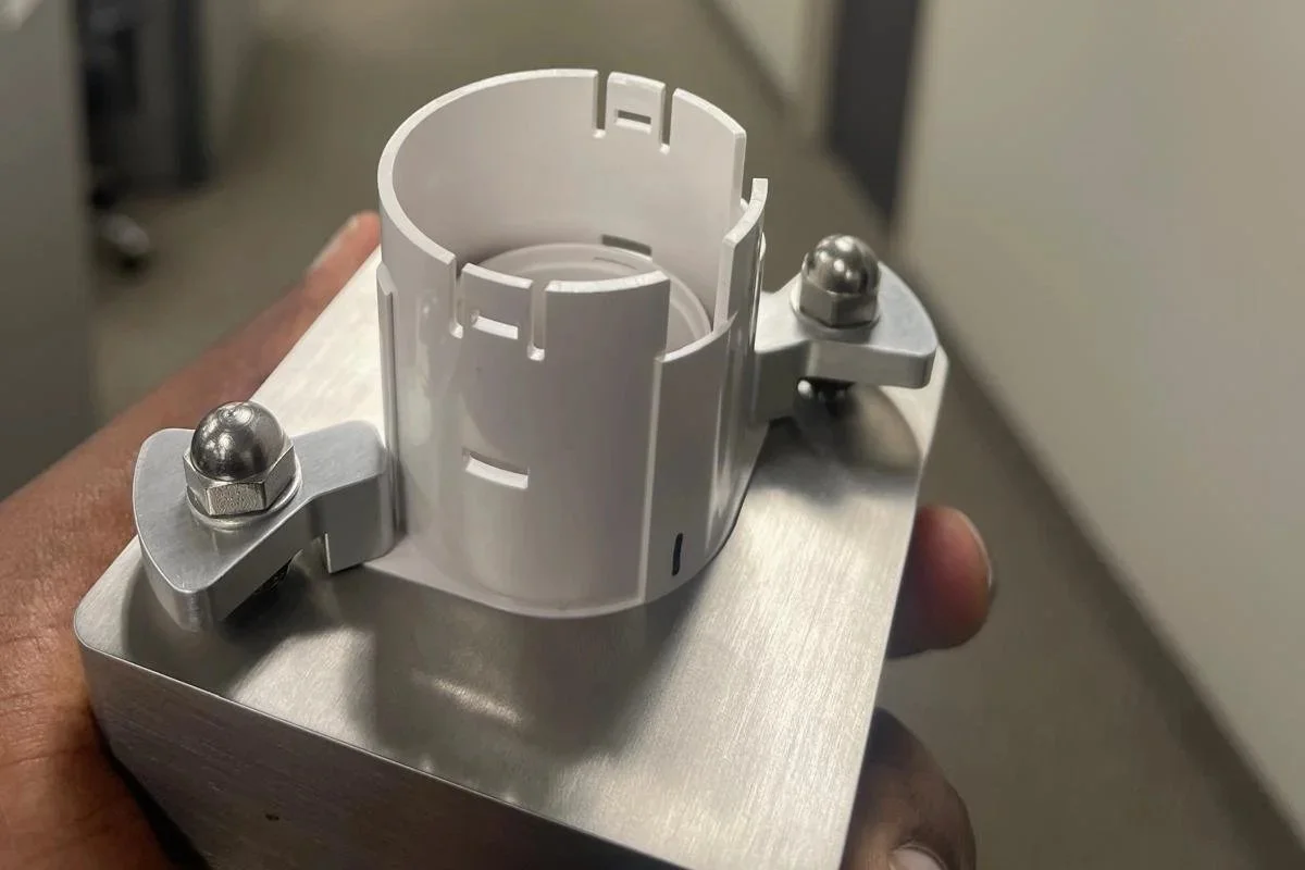 A simple spring loaded fixture to hold the plastic component against the datums