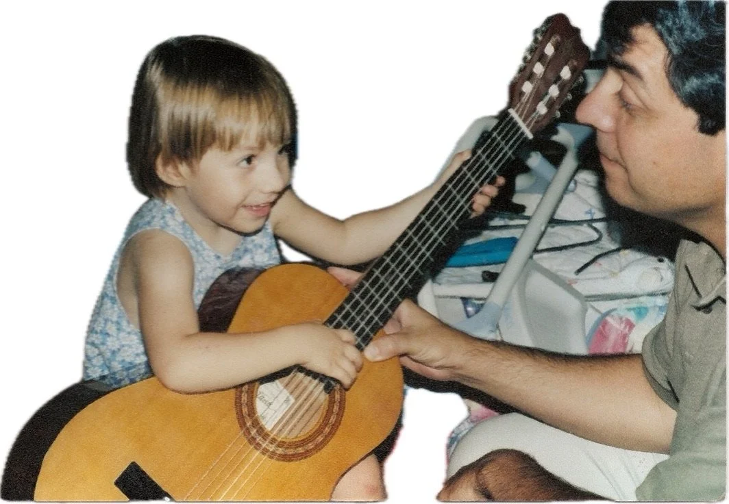 Teaching my 2 year old daughter her first guitar lesson. Now, a lifelong music enthusiast with training in flute and piano and my trusted music critic.