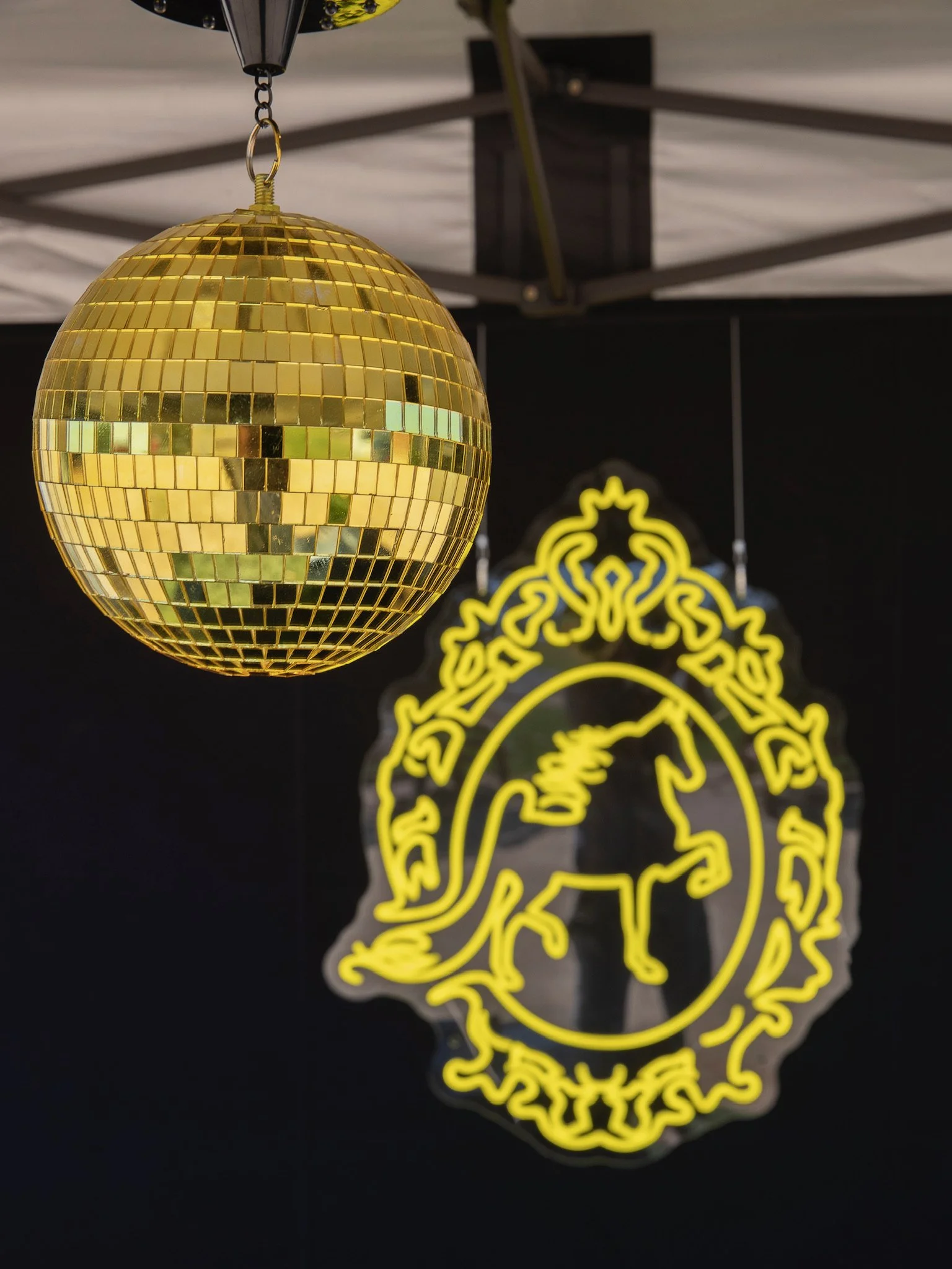Golden Glen Stables show set up with neon lights and gold disco ball.