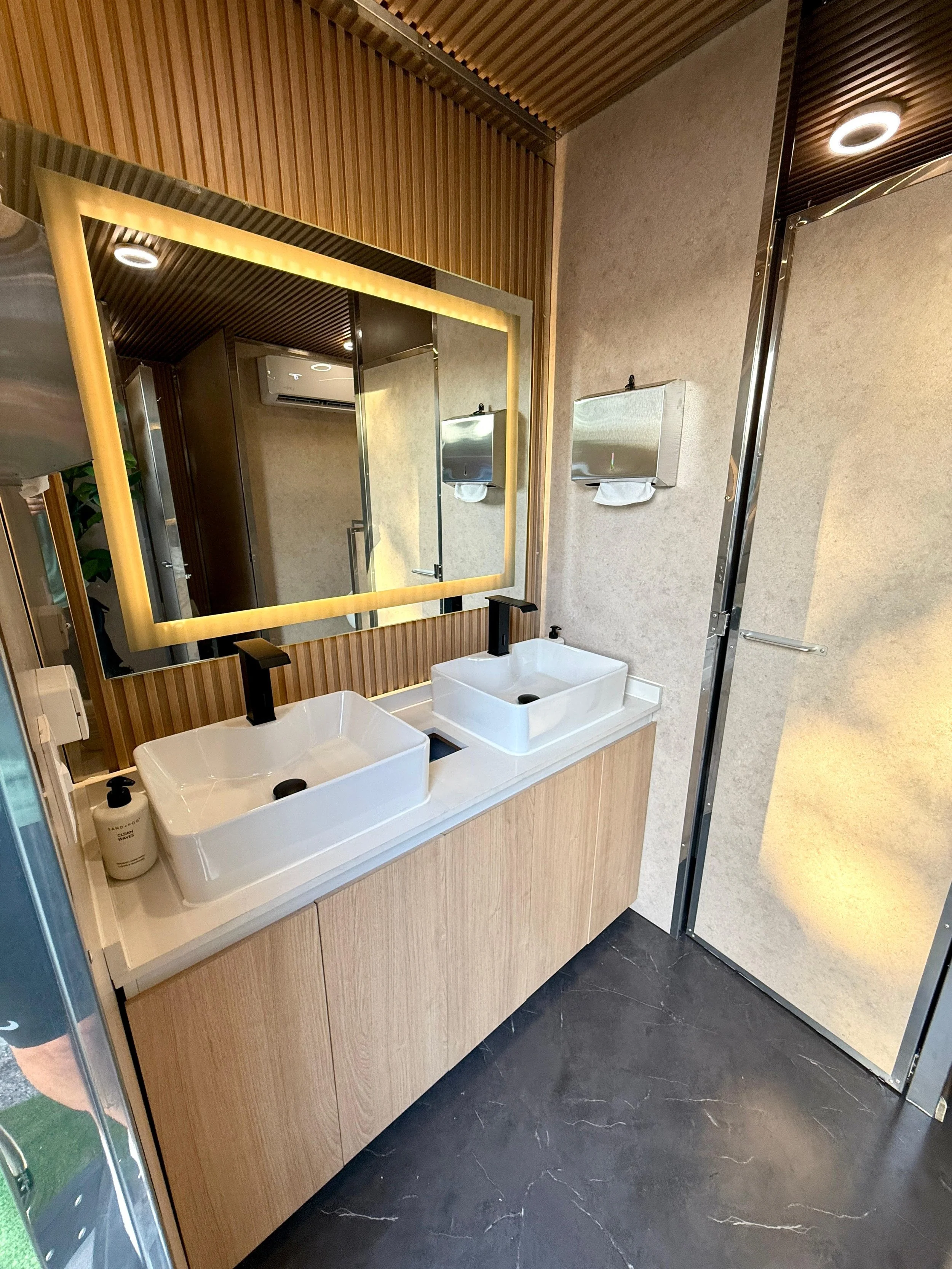 interior of mirrored bathroom trailer in Austin