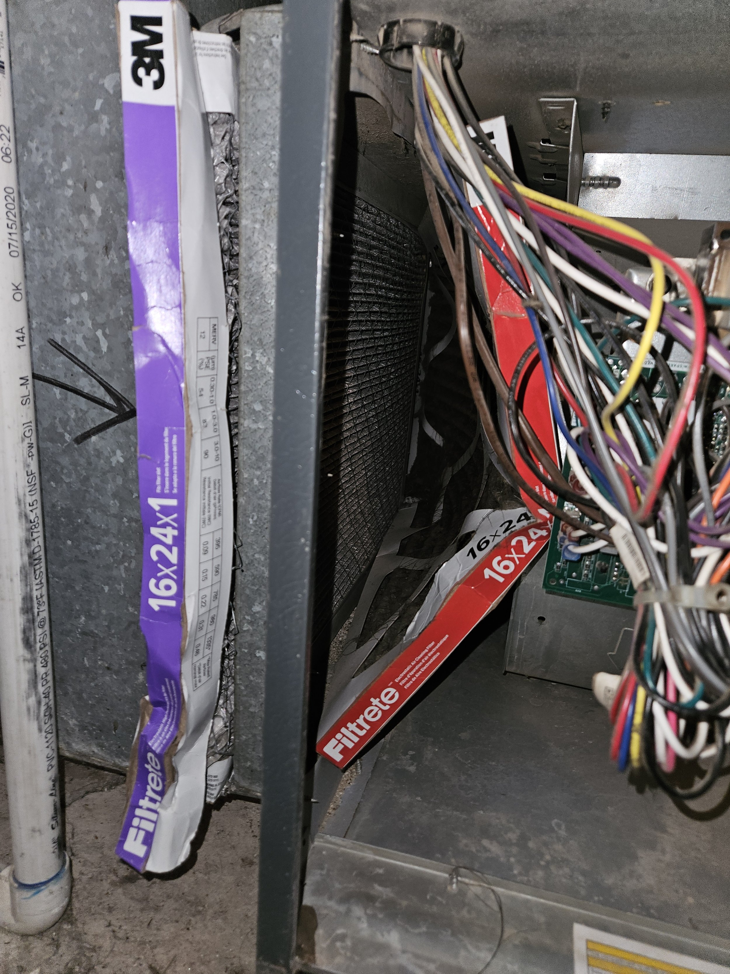 Close-up of an open HVAC system with colorful wires and filters labeled 16x24 inches.