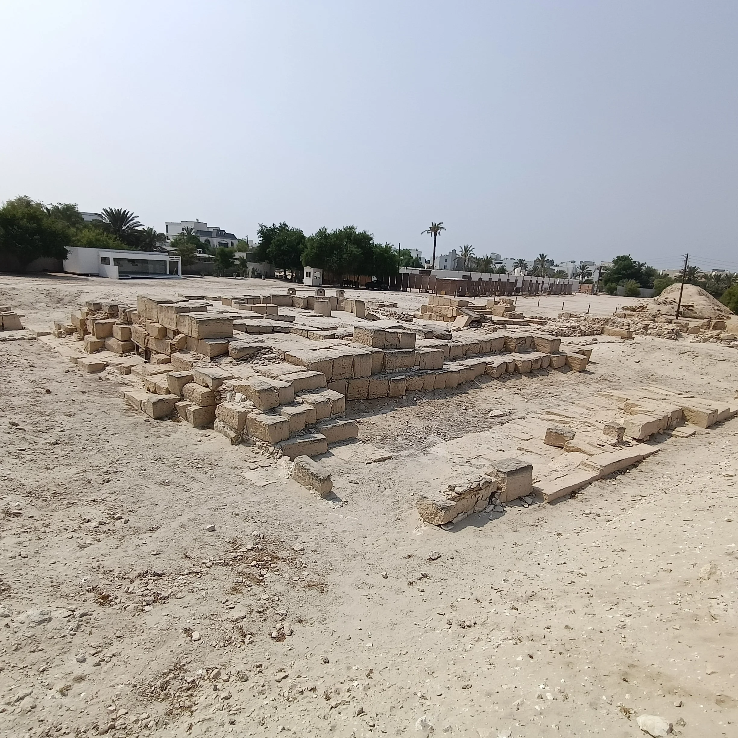 Courses of large squared blocks form low platforms and walls across the temple complex.