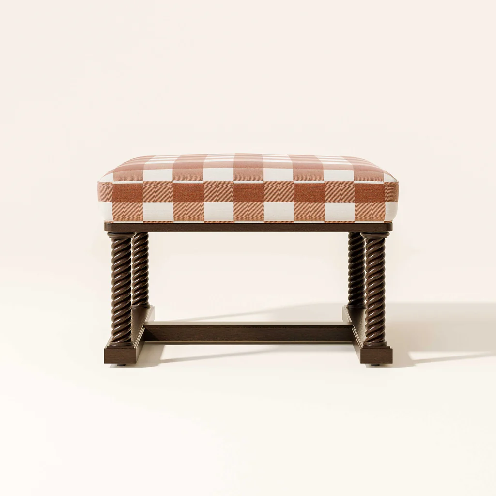 A bench with a cushioned seat featuring a red and white checkered pattern and dark brown twisted wooden legs and frame.