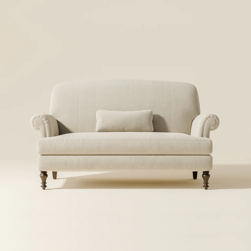 A light-colored upholstered sofa with rolled arms and a rectangular cushion on a matching wall.