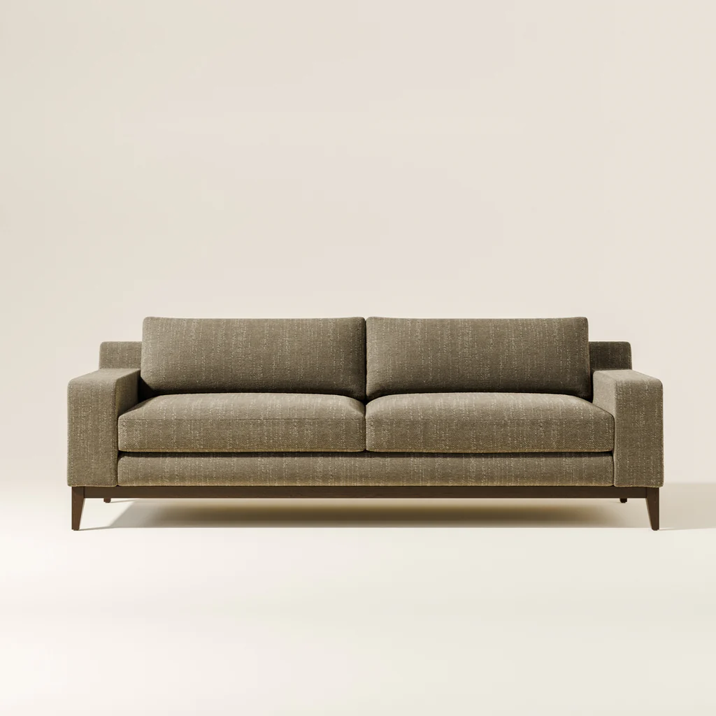 Gray upholstered sofa with two seat cushions, two back cushions, and wooden legs, placed against a plain white background.