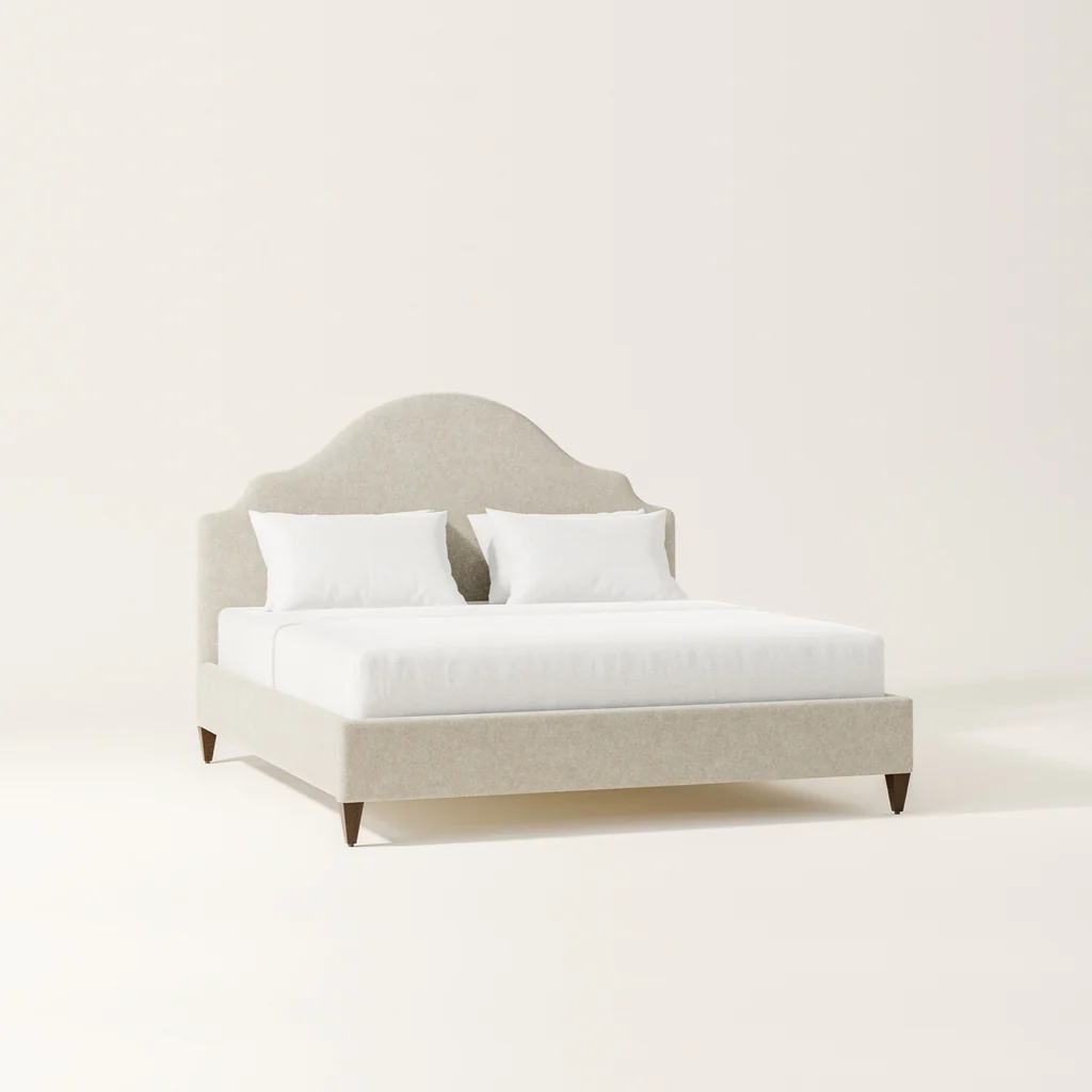 A light-colored upholstered bed with a tufted headboard, two white pillows, and white bedding, set against a plain white background.