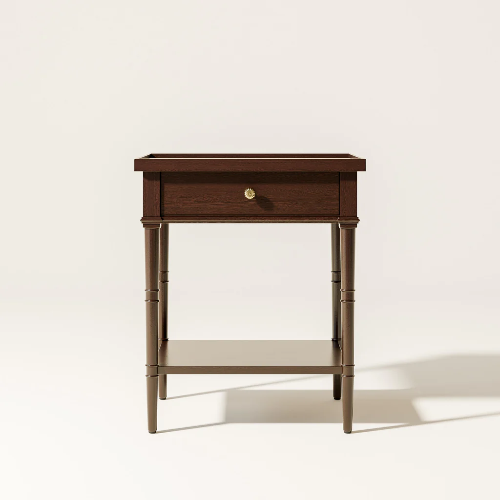 A wooden side table with a drawer and a lower shelf against a plain white background.