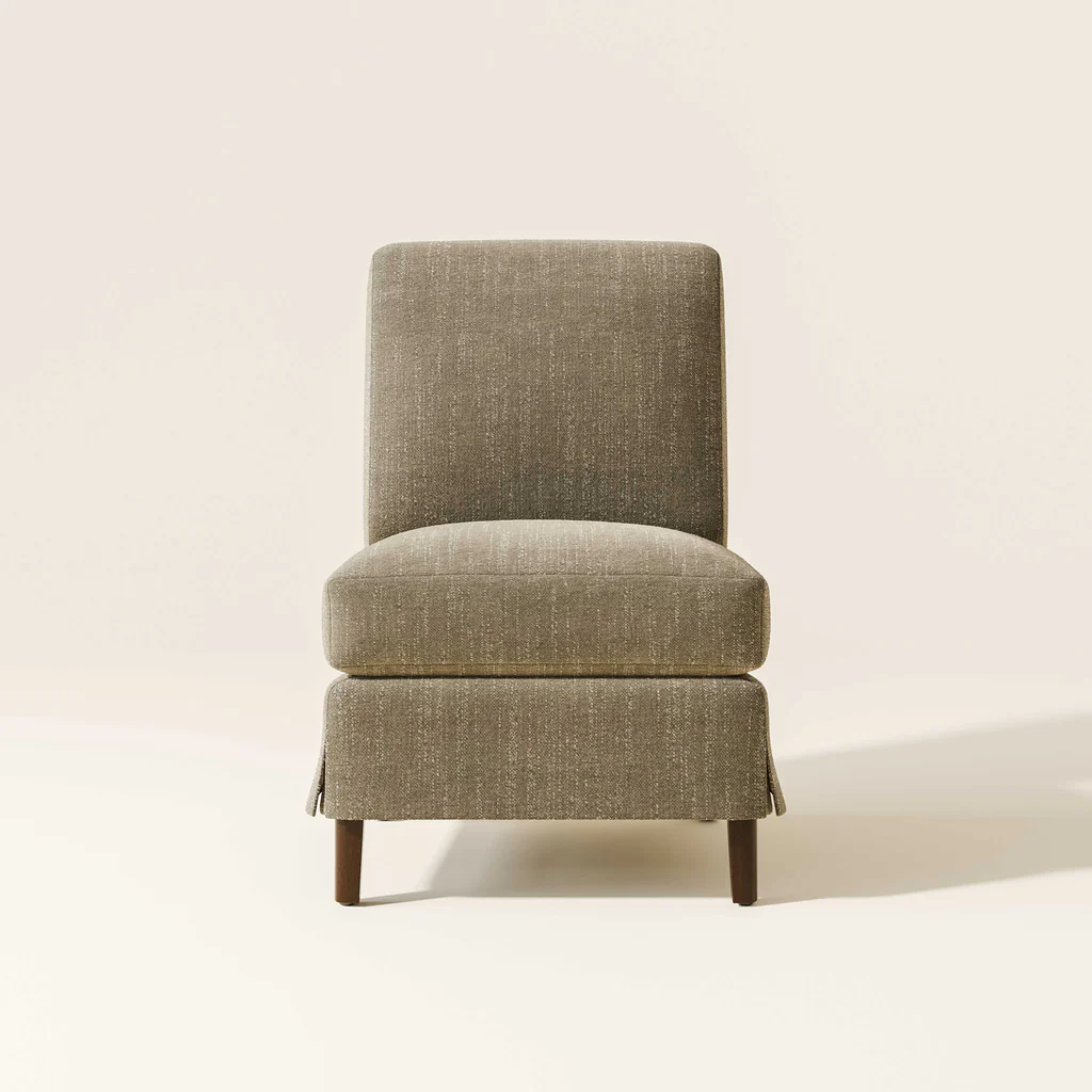 A beige upholstered armchair with wooden legs against a plain light background.