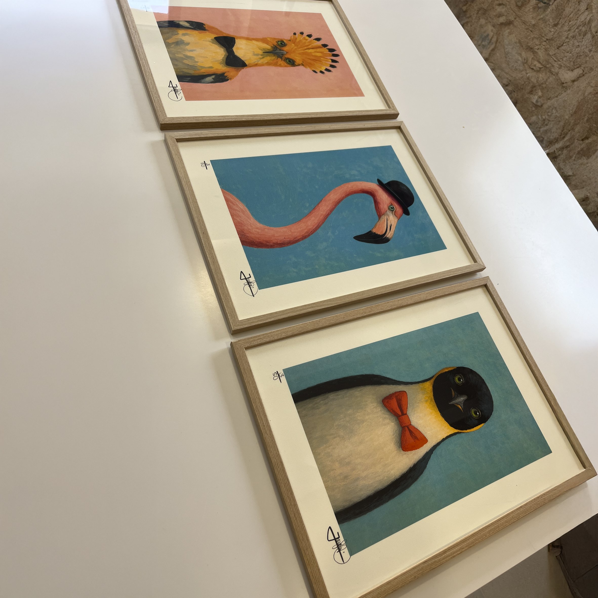 framed artprint of the Almost human art series by Jonas Skov laying on a table ready to be view by a client