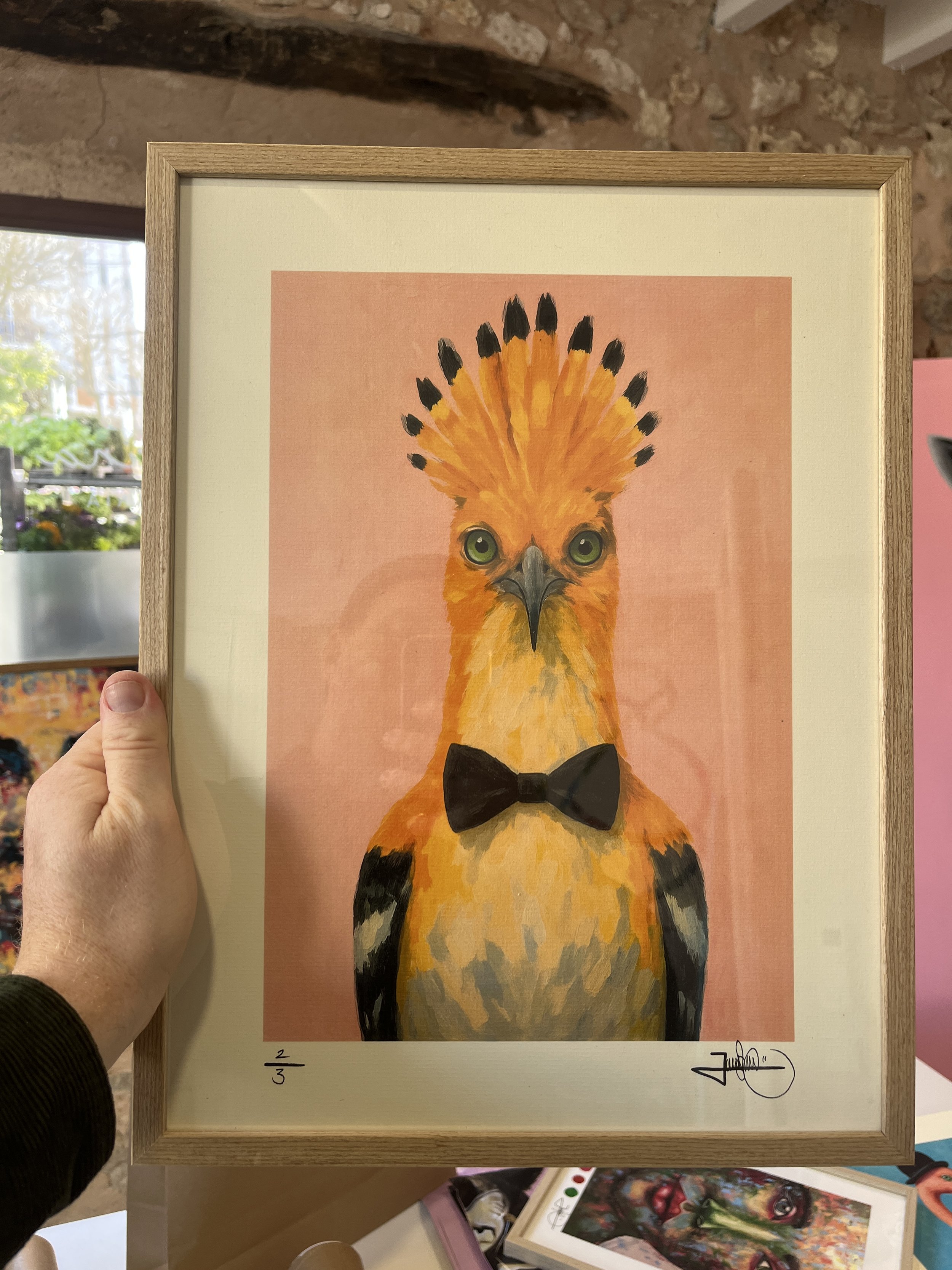 my holding a signed art pint in my art studio.