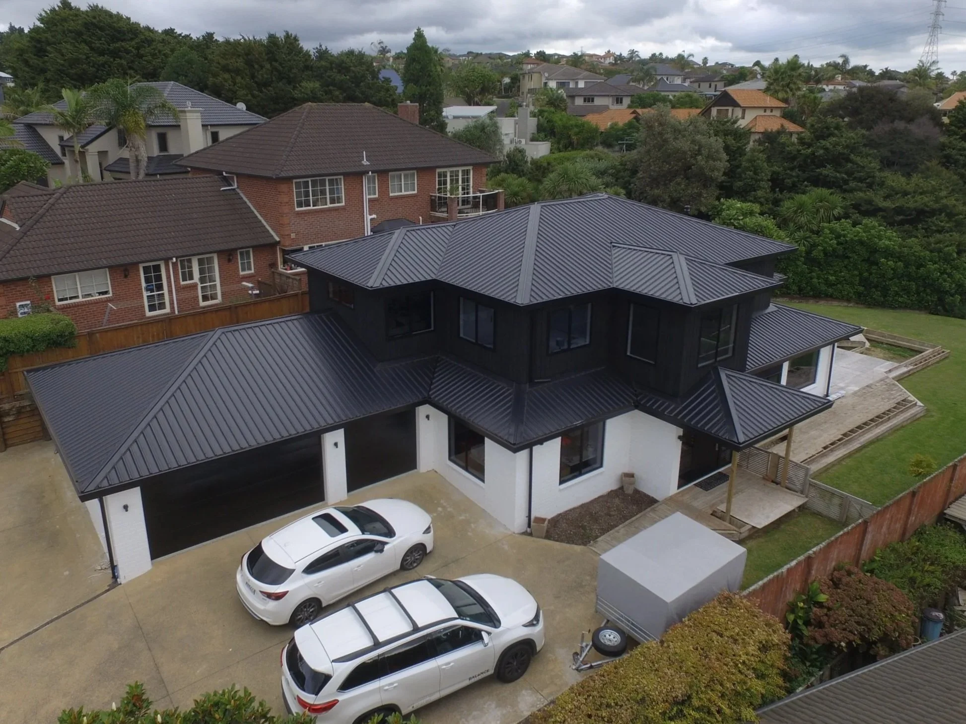 Ariel view of a residential house boasting a new roof.